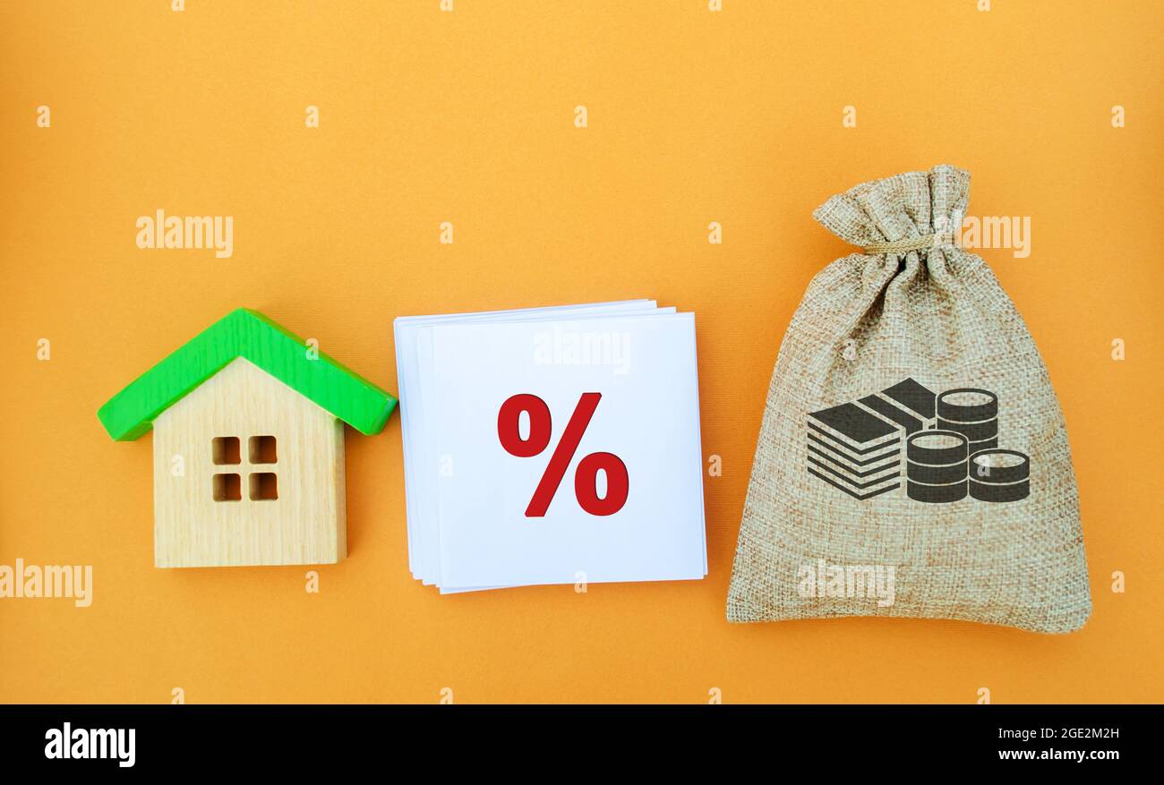 The percentage of real estate sales. Money bag, house and percent sign. Tax interest. Loan and mortgage rates. Business and finance concept. Housing i Stock Photo