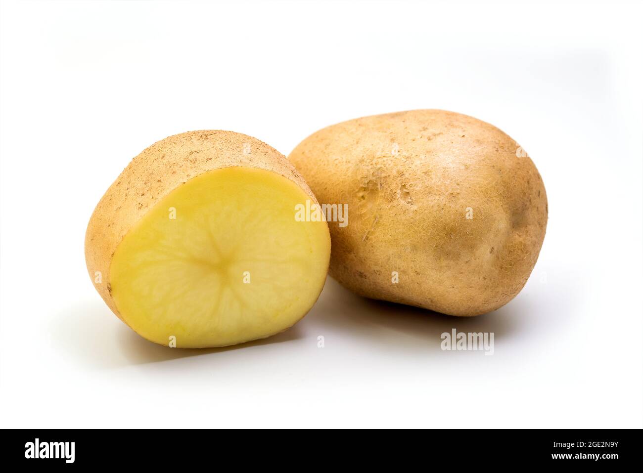 Potato - Whole and sliced in half Potato Isolated on white background with clipping path Stock Photo