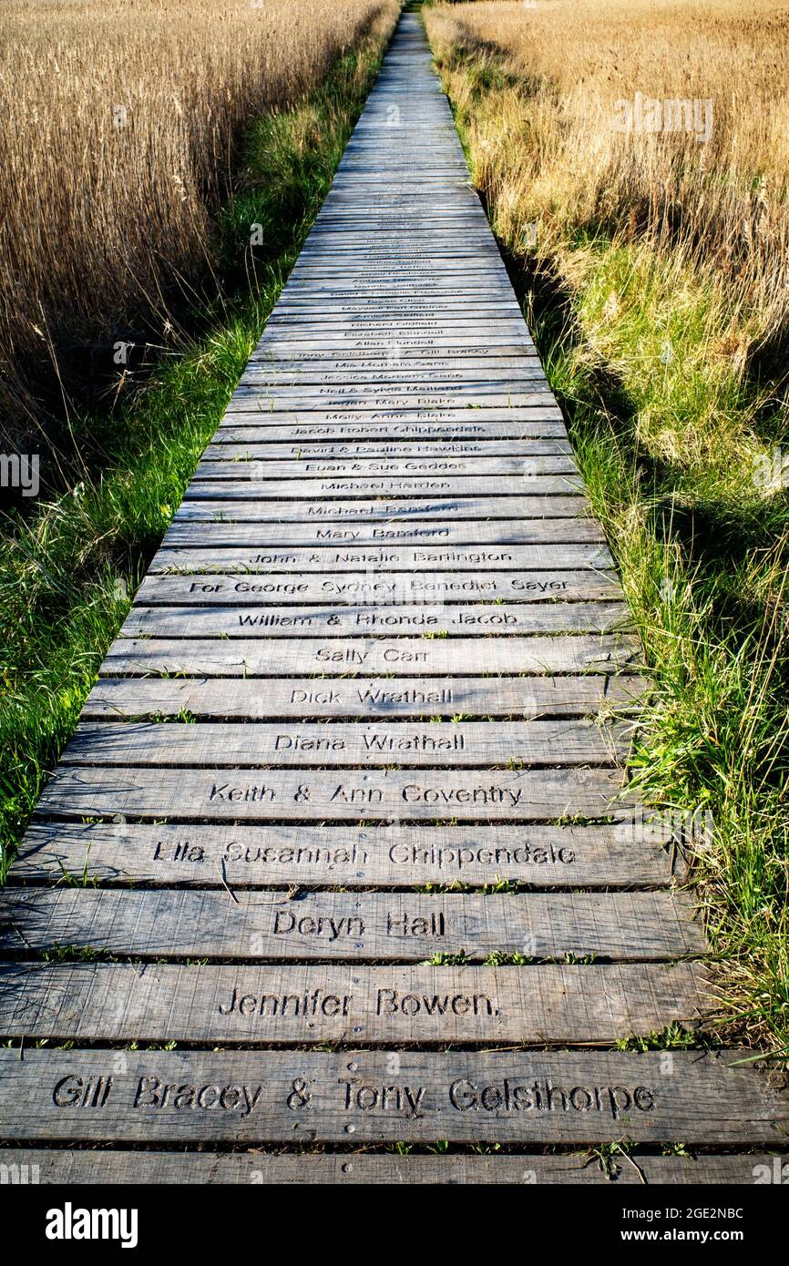 Named sponsors of a wooden walkway Snape Matings Suffolk Stock Photo