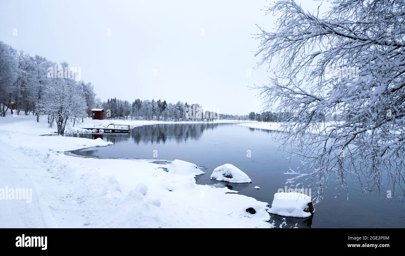 Beautiful quiet lake winter lake with snow in Sweden. Perfect for peaceful, relaxing and adventurous vacations. White mood, Christmas atmosphere. Stock Photo