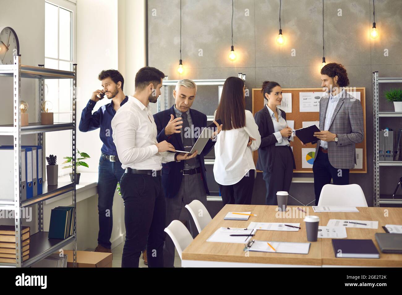 Busy company workers working on their projects in a modern office of their company Stock Photo