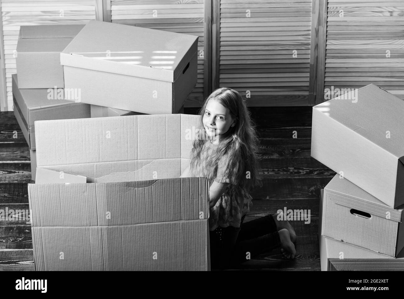 https://c8.alamy.com/comp/2GE2XET/happy-child-box-repair-of-room-new-apartment-unpacking-moving-boxes-happy-little-girl-sit-in-room-on-boxes-cardboard-boxes-moving-to-a-new-2GE2XET.jpg