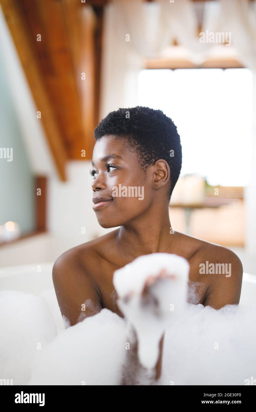 Smiling african american woman in bathroom relaxing in foam bath Stock Photo - Alamy