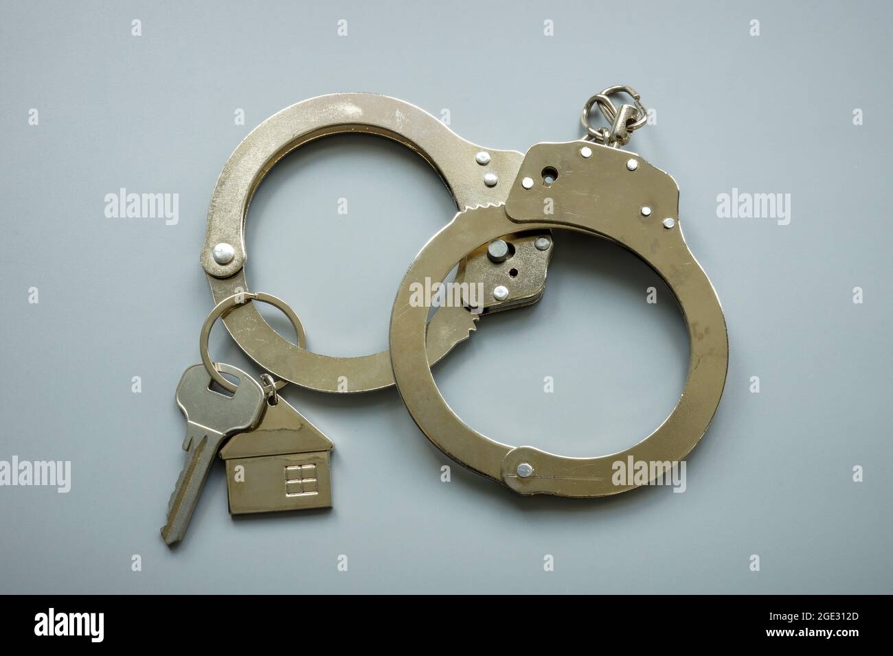 Handcuffs and house keys. Rent or mortgage relief concept. Stock Photo