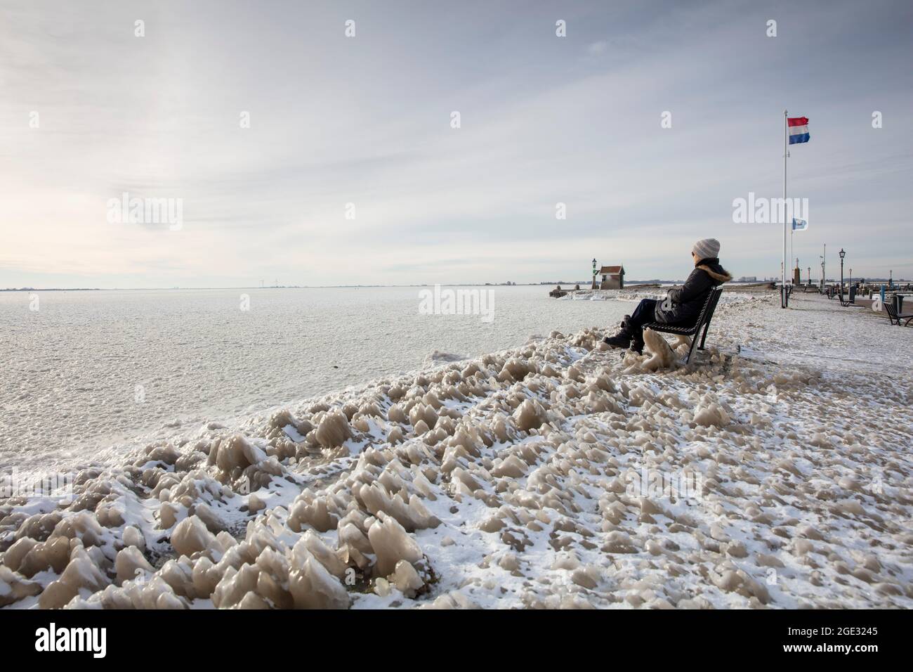 The Netherlands, Volendam, harbour, winter, frozen, frost, ice, woman. Markermeer. Stock Photo