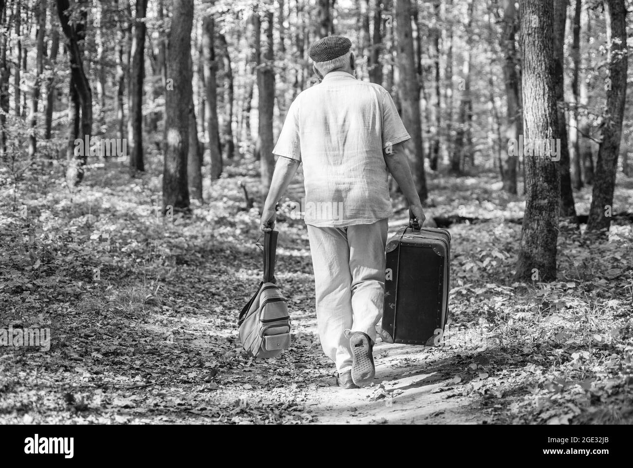 Retirement and hobbies. Always have bag ready to go. Elderly carry travel bag. Old man travel with retro bag. Living vagabond life. Vacation Photo - Alamy
