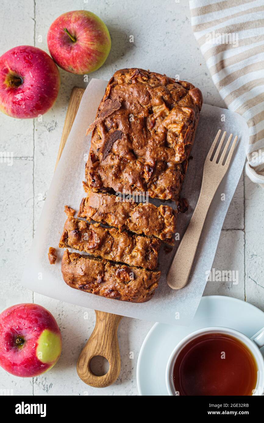 Apple bread on a wooden board. Autumn fruit pie, gray background, top view. Stock Photo