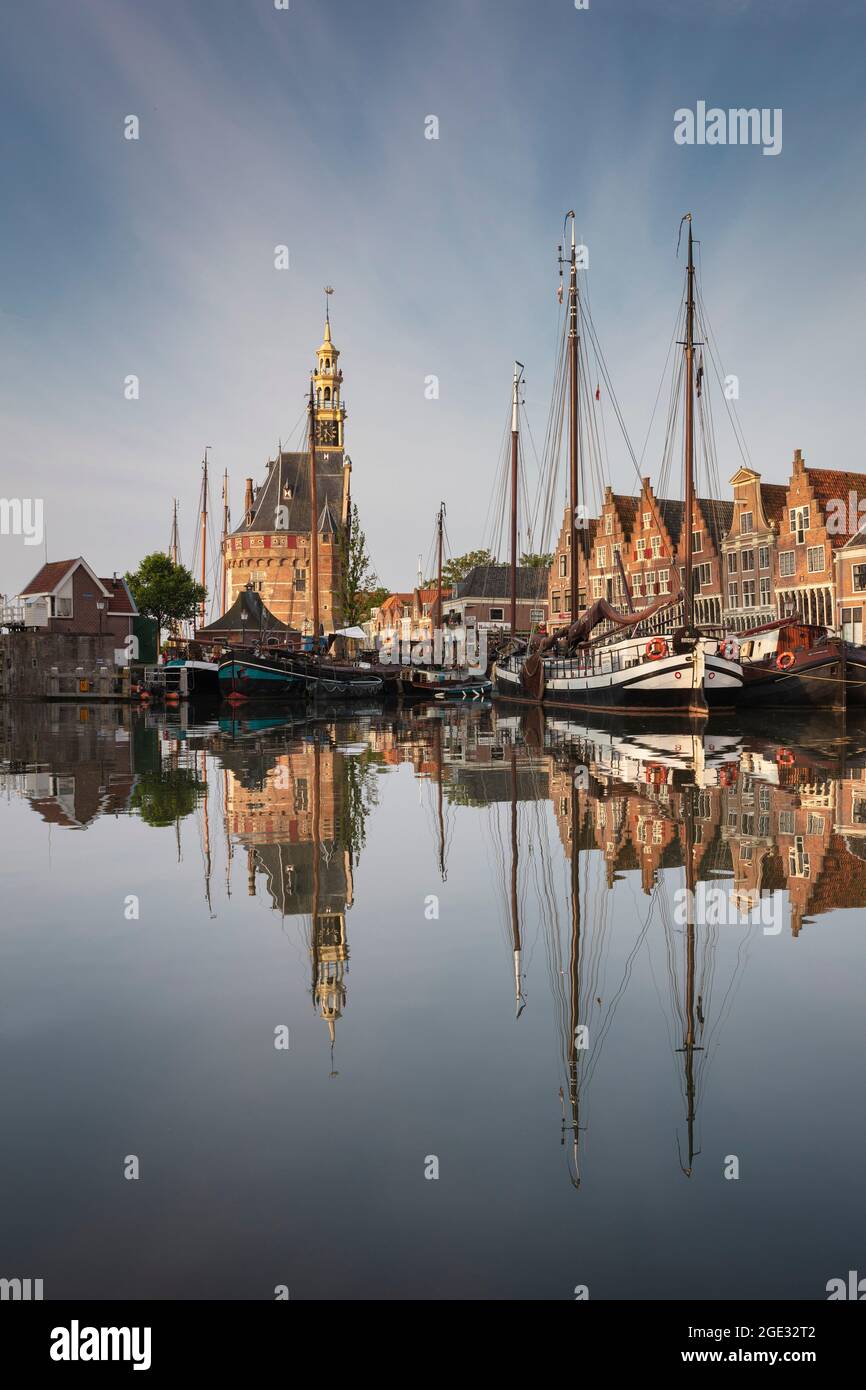 The Netherlands, Hoorn. Historic city center, harbour, tower called Hoofdtoren. Traditional sailing boats. Stock Photo