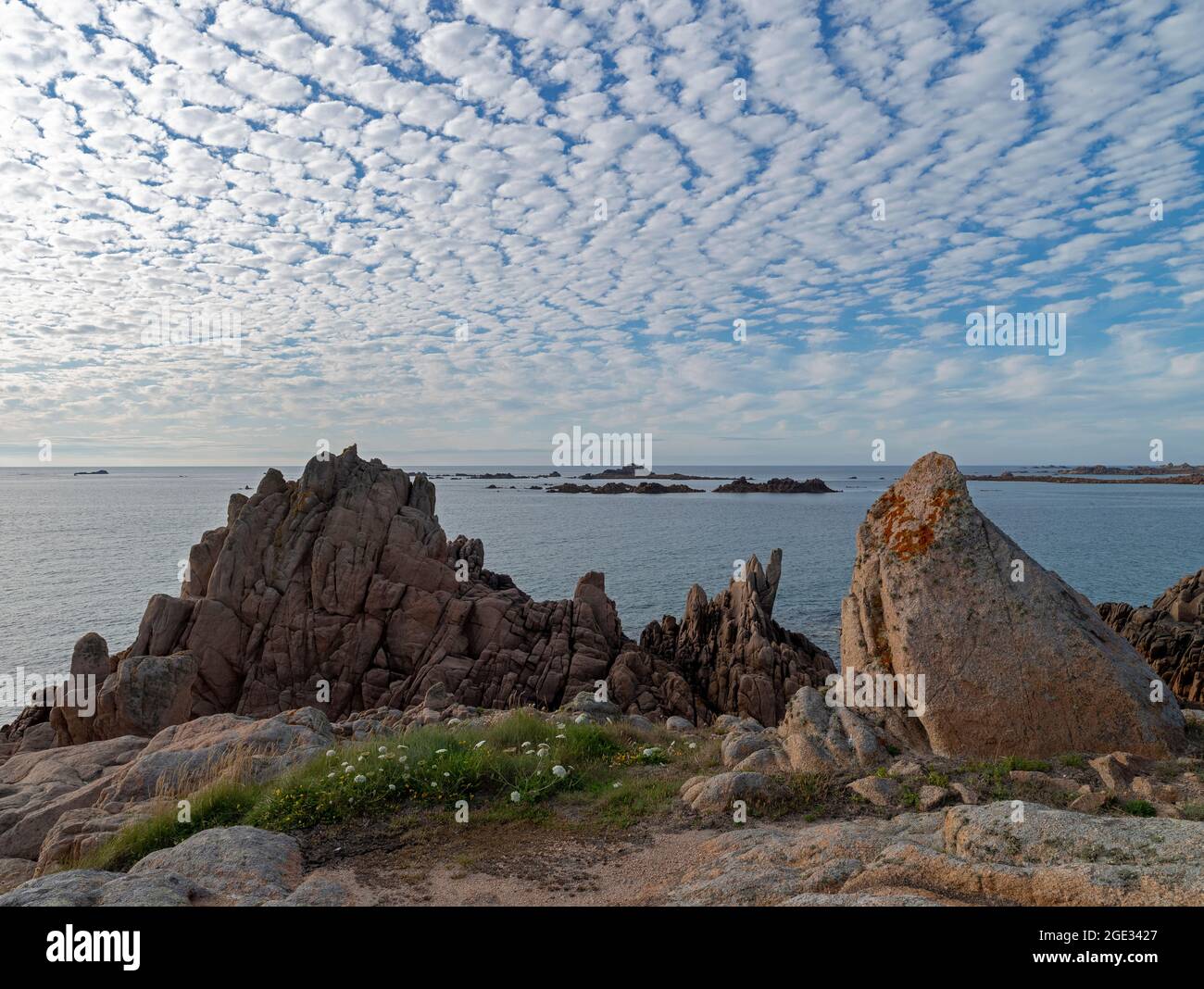 Coastal rocks with a mackerel sky Stock Photo