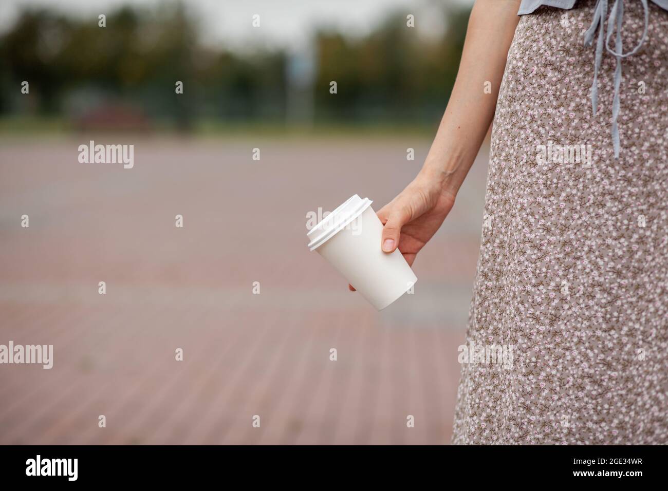 White paper cup with coffee in woman hand. Time for drink coffee in ...