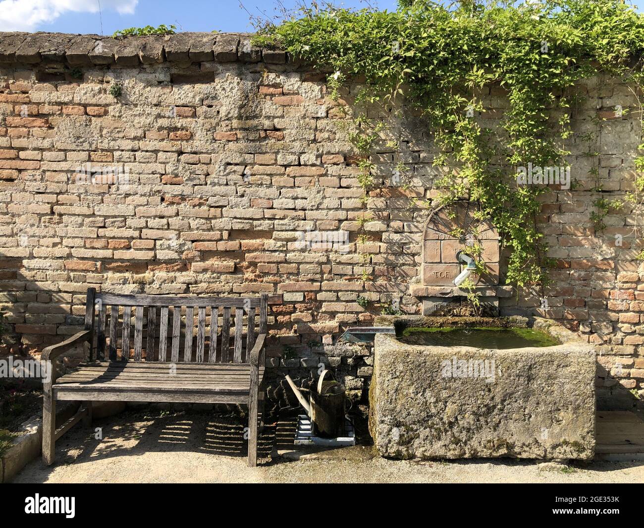 Old wooden bench in front of brick wall in Schloss Hof garden Stock ...