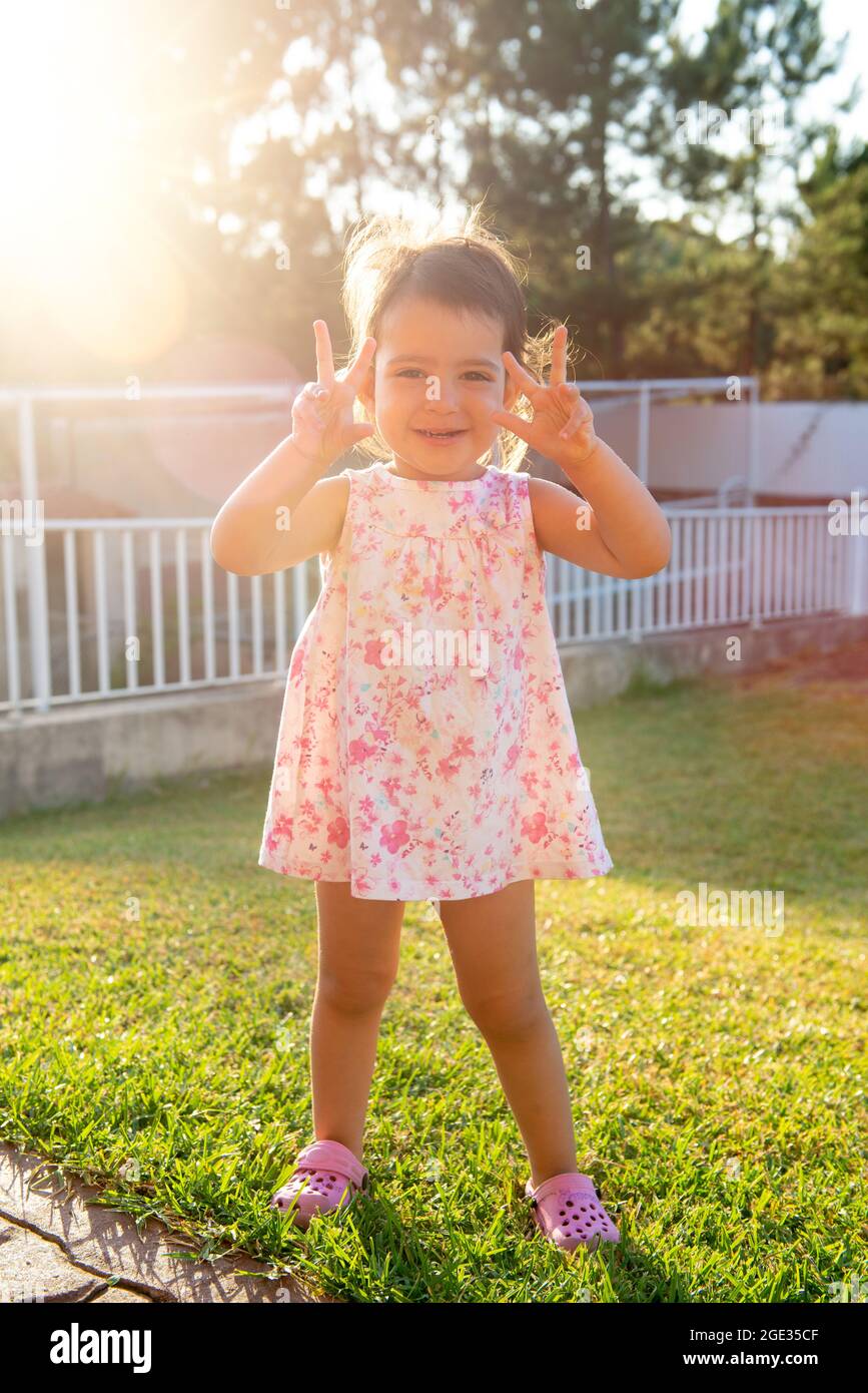 Sweet young girl posing outdoors at sunset Stock Photo
