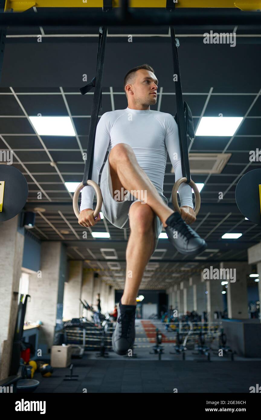 Muscular man doing endurance exercise on the rings Stock Photo Alamy