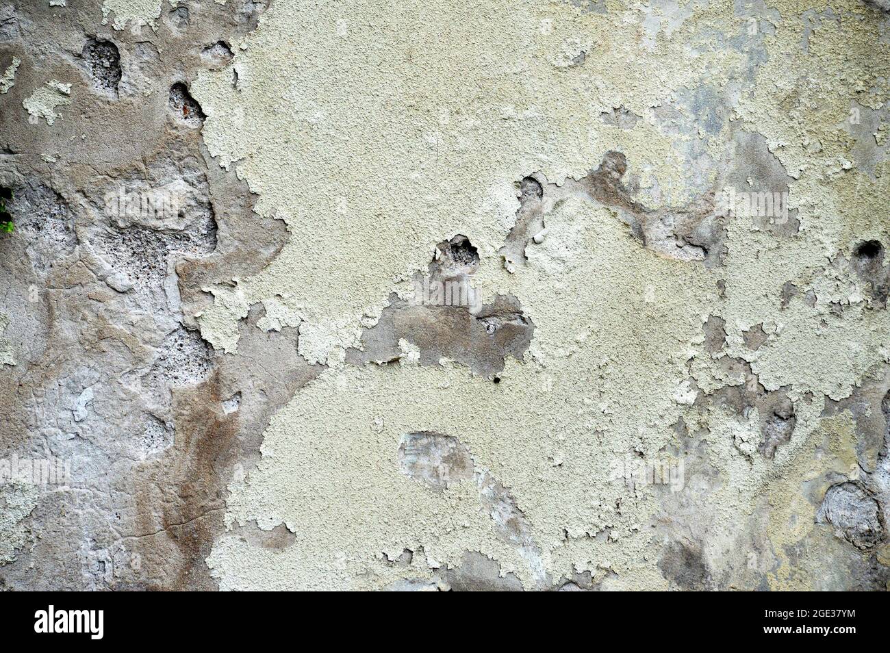 Old concrete wall with peeling plaster Stock Photo