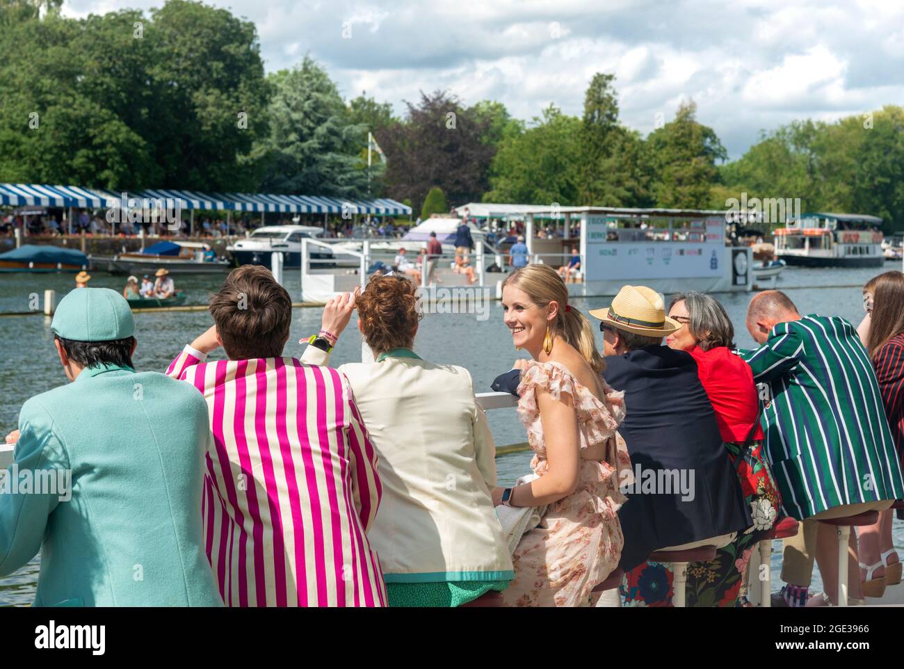 Spectators watch the rowing from the Steward's Enclosure,men wearing rowing club blazers, at the Henley Royal Regatta 2021, Henley-on-Thames,England Stock Photo