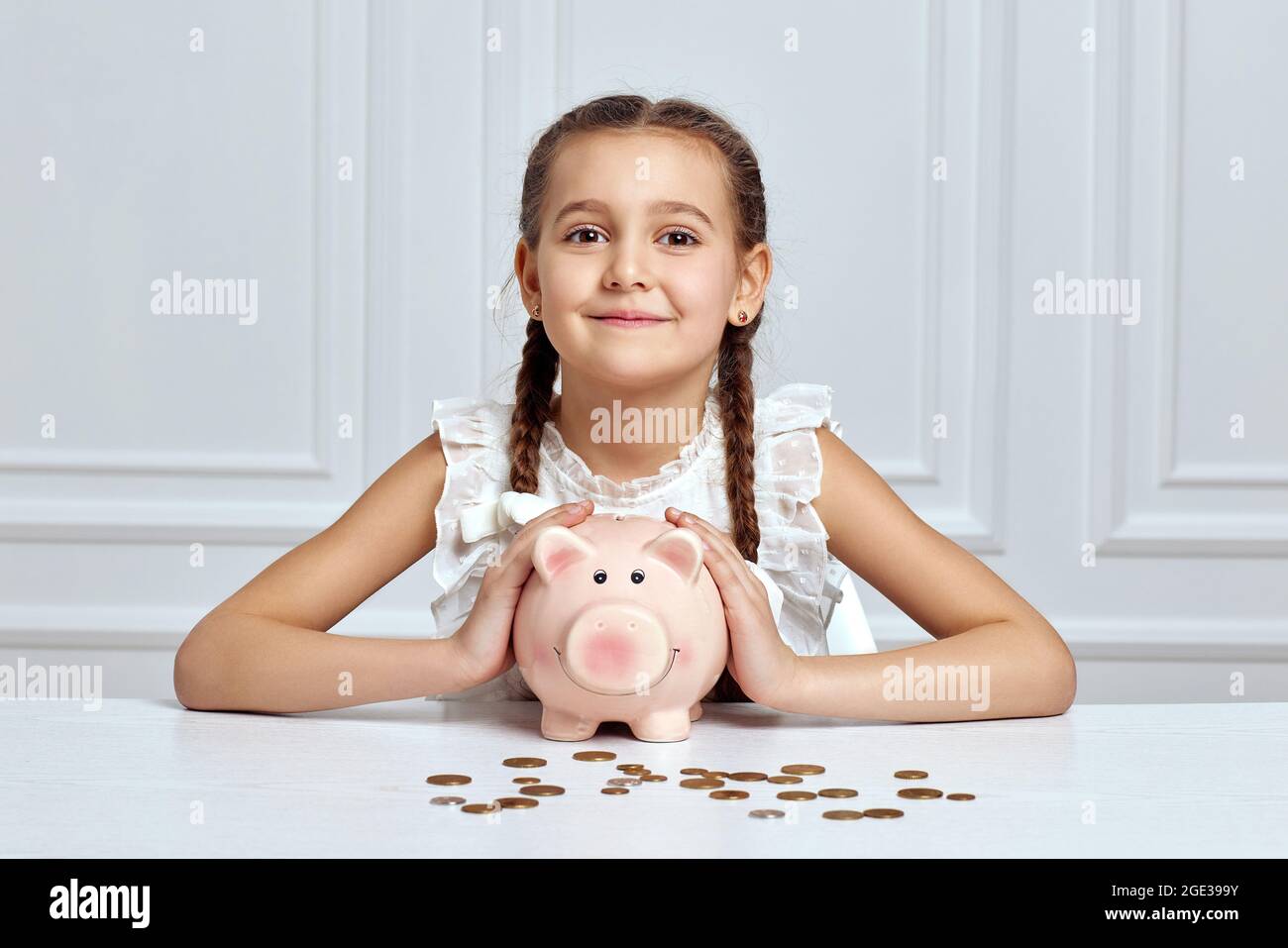 Little child girl with piggy bank at home Stock Photo - Alamy