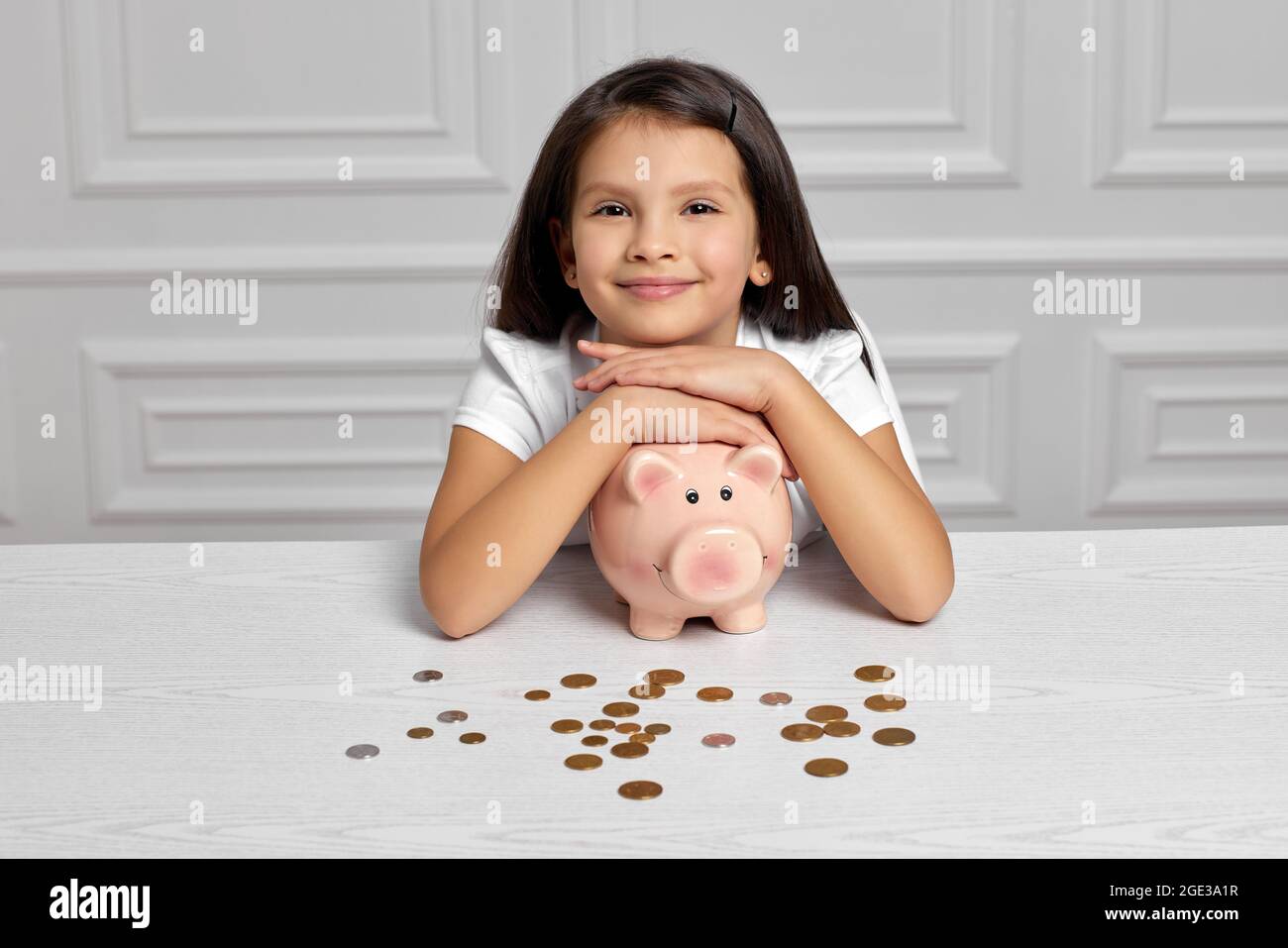 Little child girl with piggy bank at home Stock Photo - Alamy