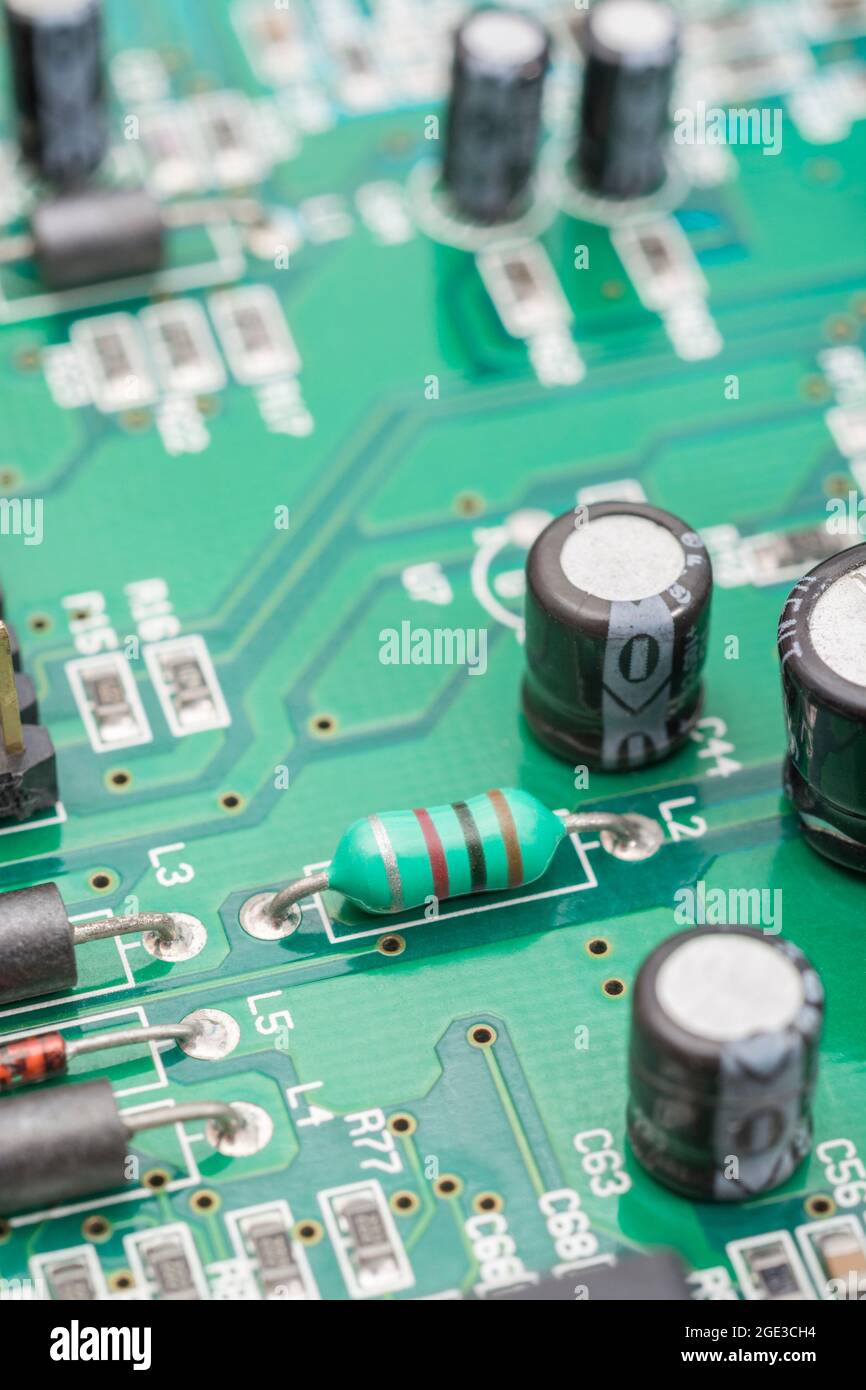Close up shot of ferrite leaded inductor or axial lead inductor (at L2) shaped like a resistor on green pcb. Unsure if shielded type or not. SEE NOTES Stock Photo