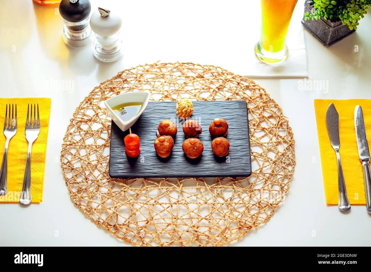 Hot canapes with olive oil in a gravy boat.  Stock Photo