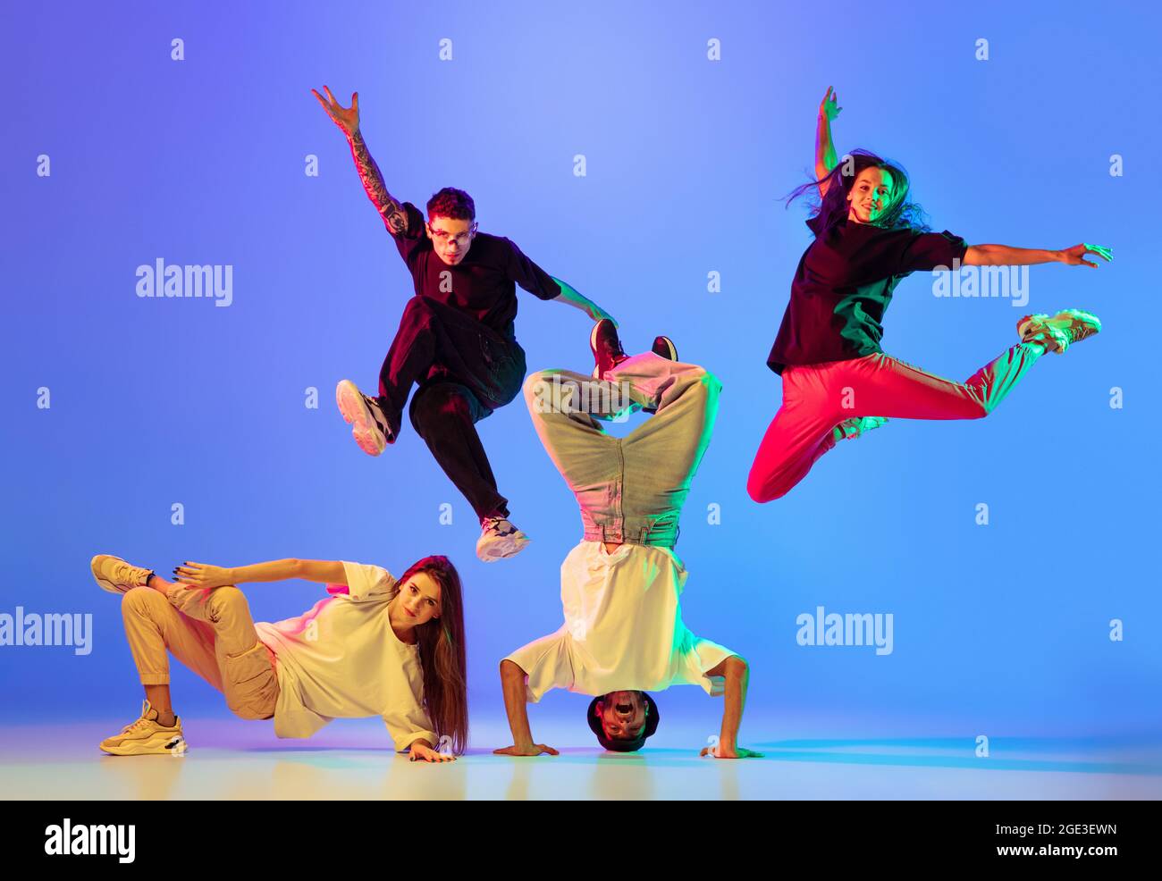 Group of young people, guys and girls in dancing contemporary dance, hip-hop, brakedance over blue background in neon light Stock Photo - Alamy Group of young people, guys and girls in dancing contemporary dance, hip-hop, brakedance over blue background in neon light Stock Photo - Alamy
