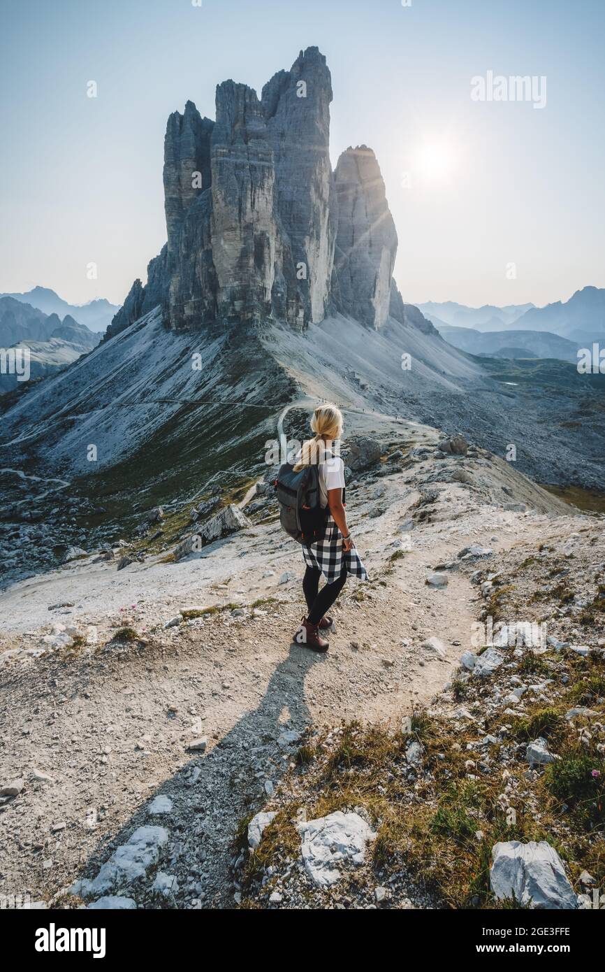 Women hiker with backpack in hiking trail at the Tre Cime di Lavaredo. Dolomites, Italy Stock Photo