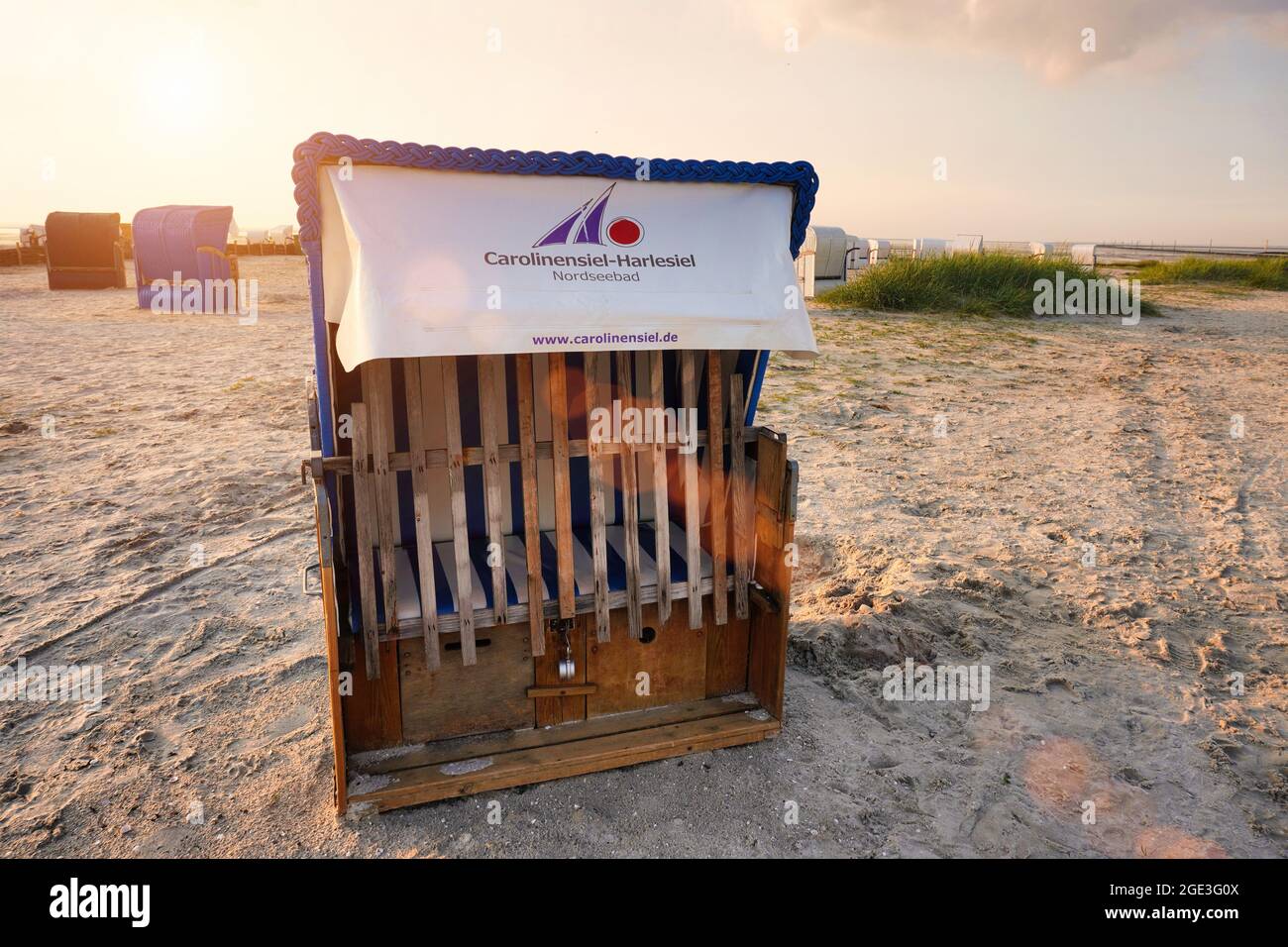 Typical beach chair, called Strandkorb, on the beach. North Sea resort Carolinensiel-Harlesiel in East Frisia, Lower Saxony, Germany. Stock Photo