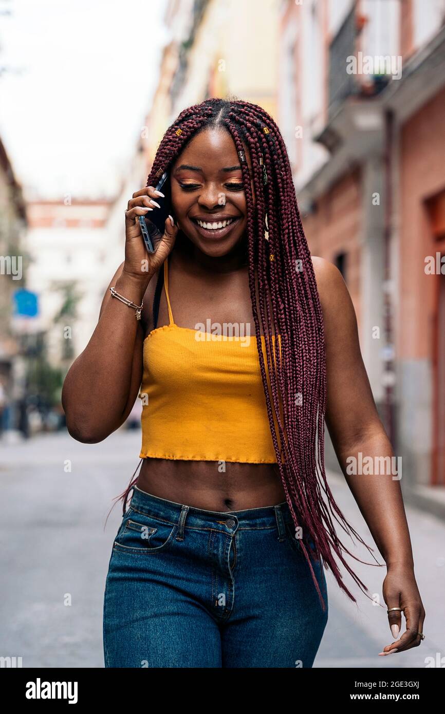 Smiling african woman braids using hi-res stock photography and images ...