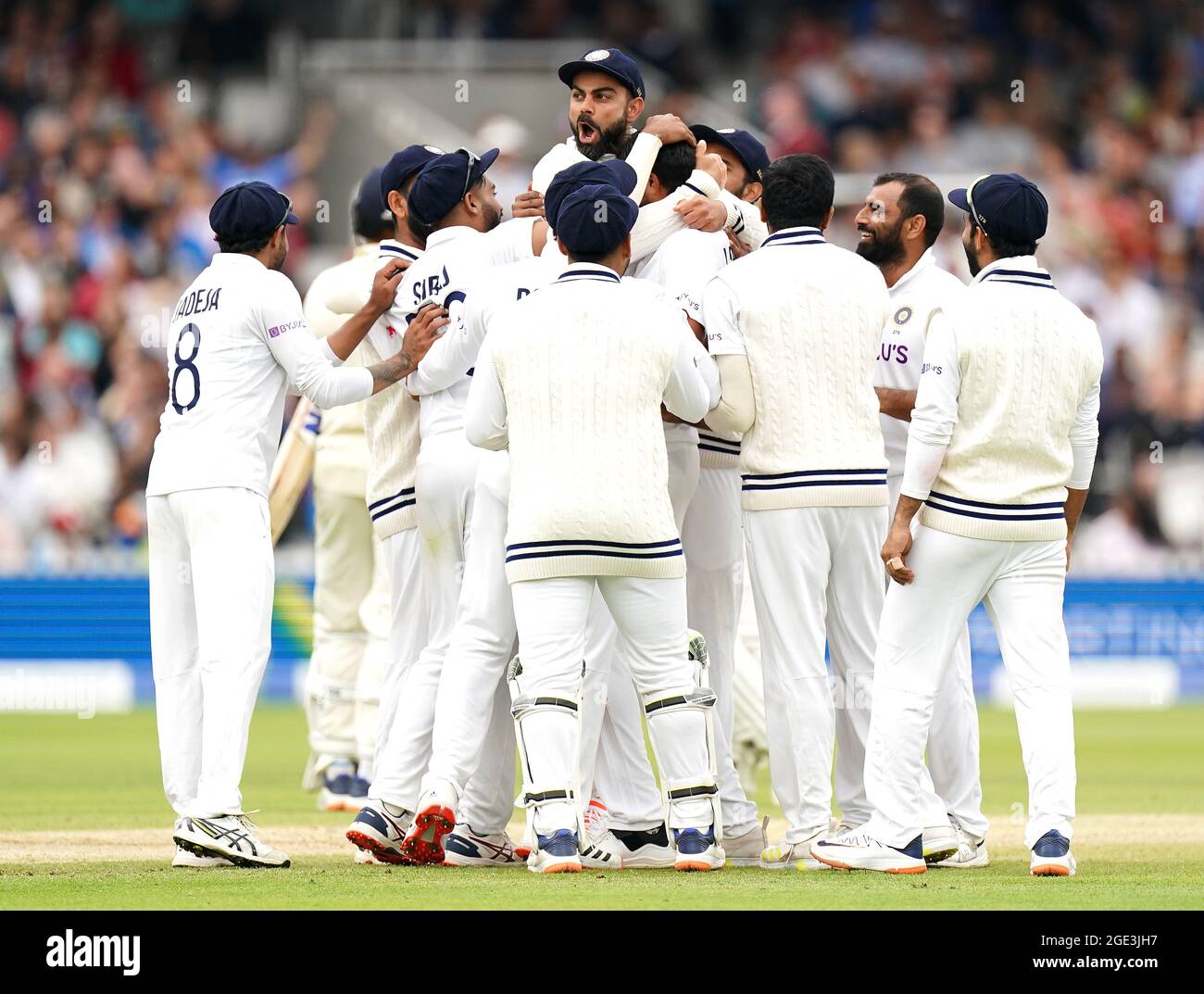 Indias Virat Kohli (top) celebrates the wicket of Englands Jonny Bairstow after a video review during
