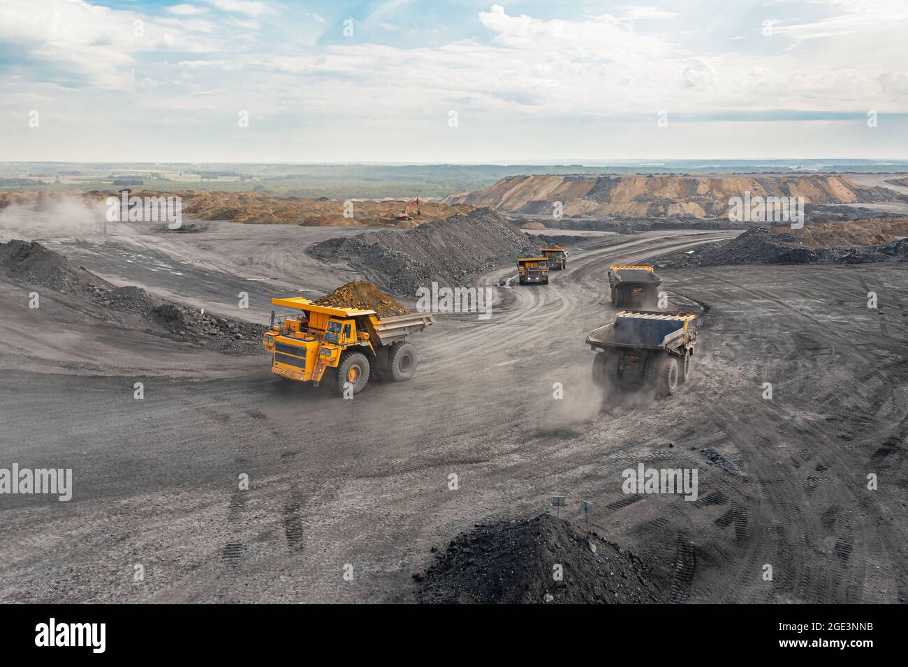 Large quarry dump truck. Big yellow mining truck at work site. Loading ...