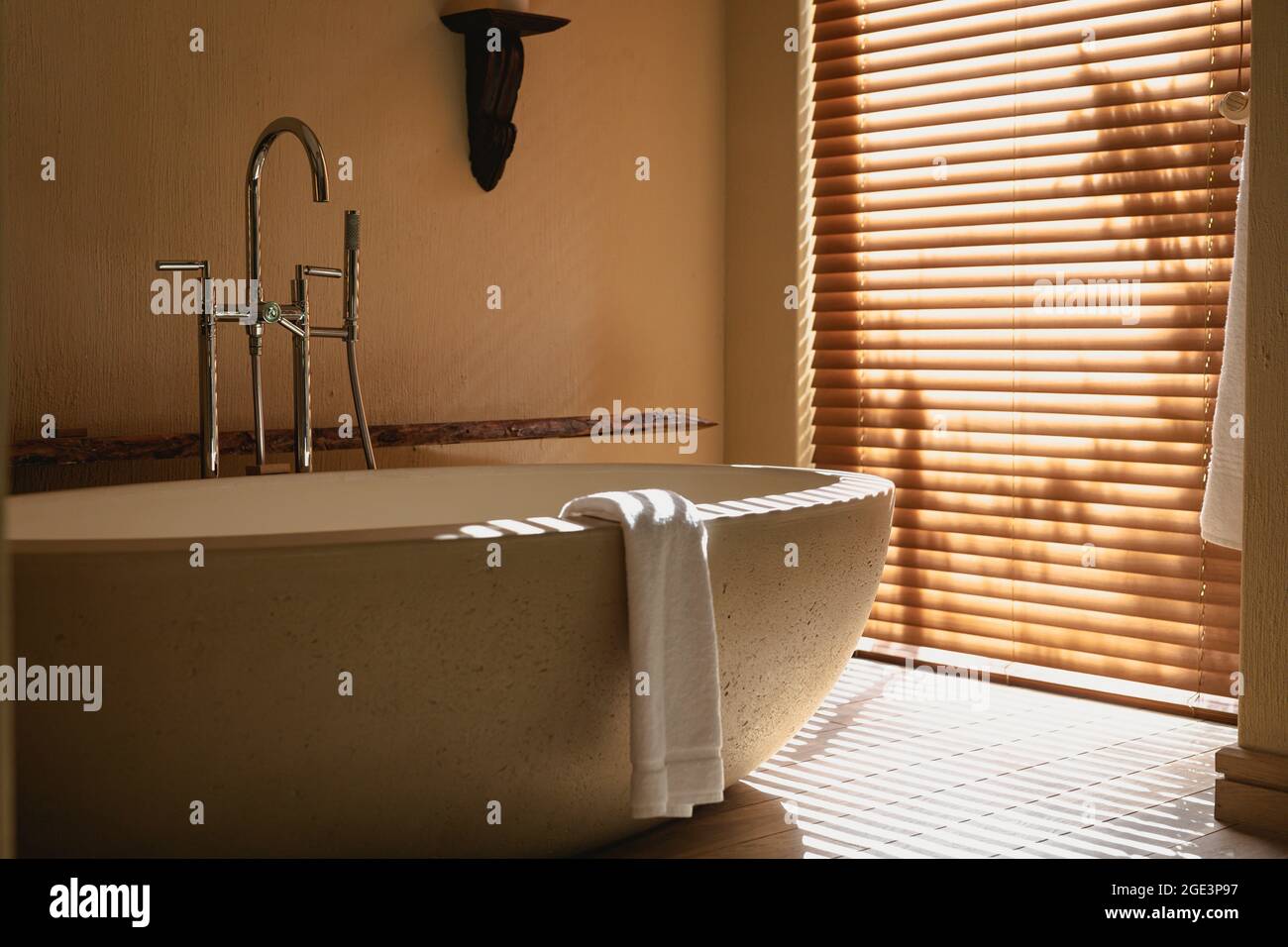 Interior of sunny, modern bathroom with beautiful designer bath Stock Photo
