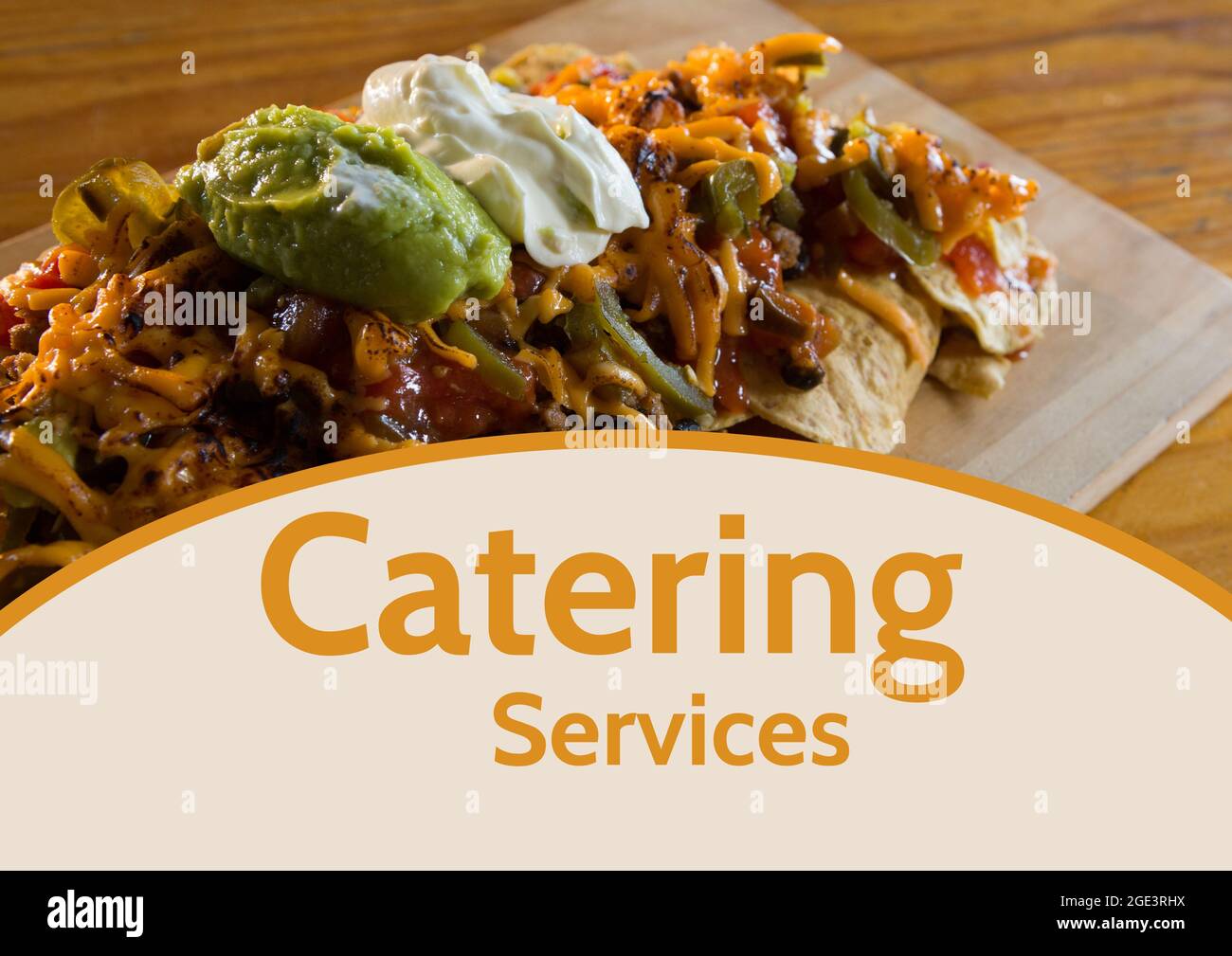 Composition of catering services text over food on wooden table Stock Photo