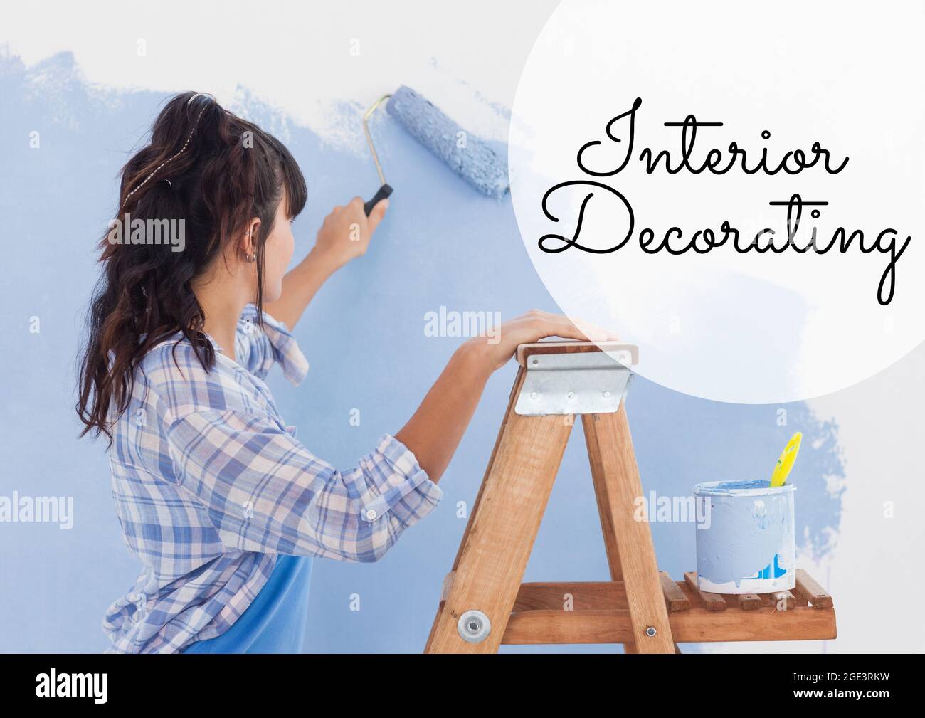 Composition of online crafting text over woman painting wall Stock Photo