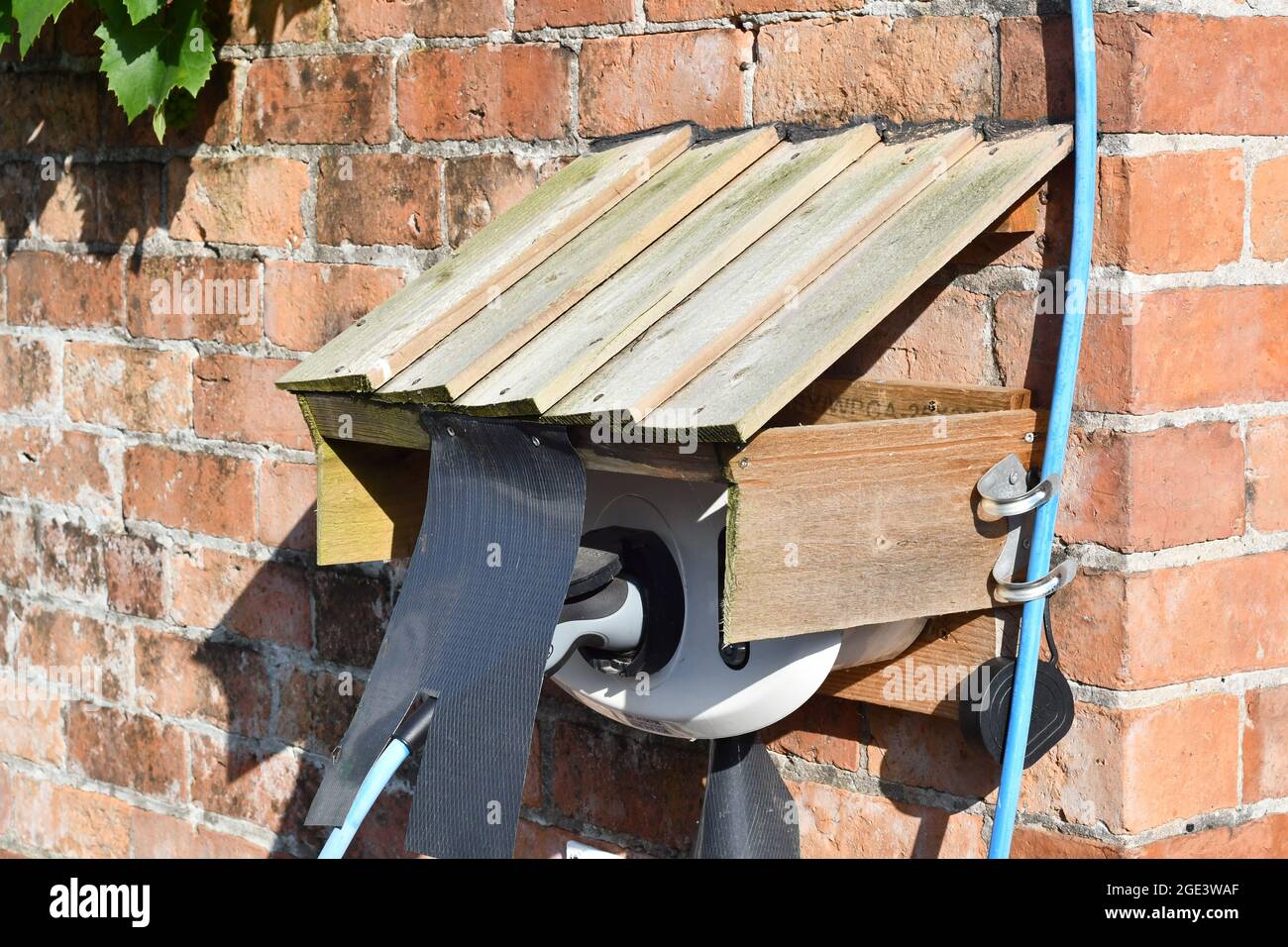 Electric Car Charger and unique housing of charging point, urban life Stock Photo