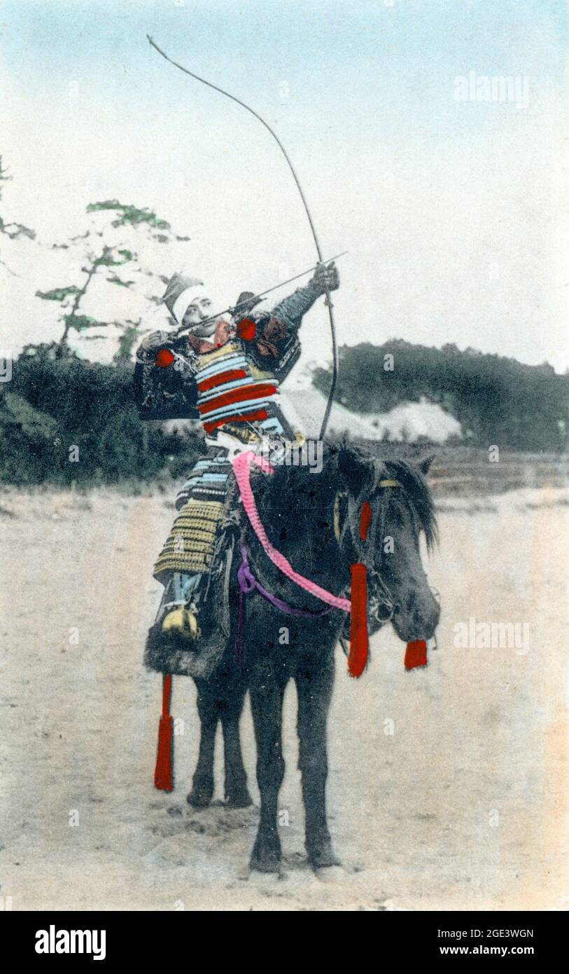 Old Japanese hand colored postcard, circa 1900, of a horse mounted archer in full samurai armour firing a bow, (yumi) and arrow. Stock Photo
