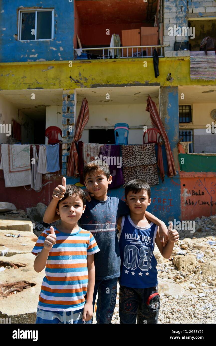 Youngsters posing for a photo in the poor neighbourhood of Ouzai