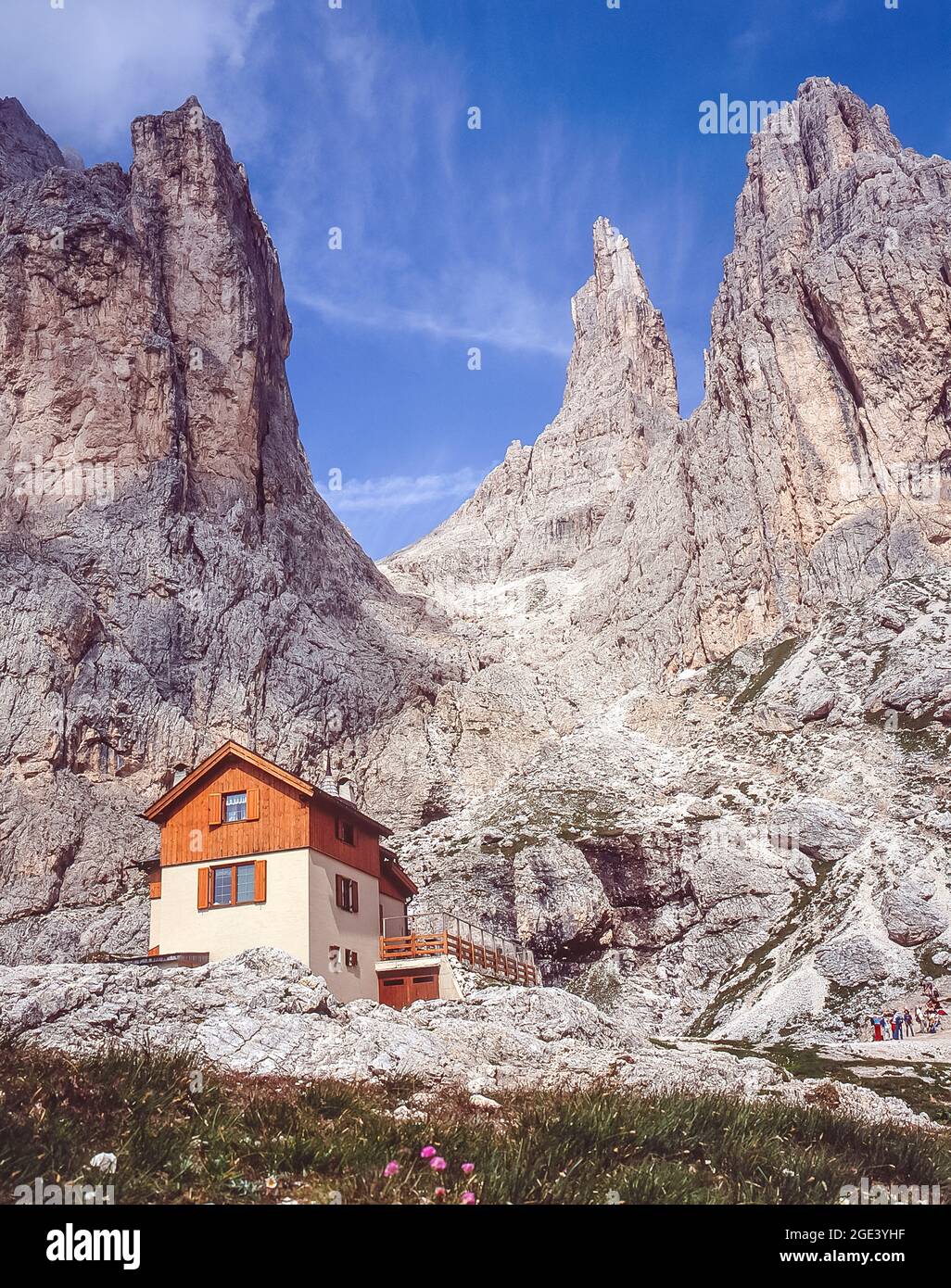 This is the privately owned Rifugio [Paul] Preuss mountain refuge close-by the formidable peaks of the Vajolet Towers in the Rosengarten Dolomites region of the Italian Dolomites, the Alto Adige of the Sud Tyrol. Film enthusiasts will remember that the Vajolet Towers were in the opening scenes of Sylvester Stallone's film Cliffhanger when a young woman fell to her death from the gap between the second and third tower seen to the top right in the photo. Stock Photo