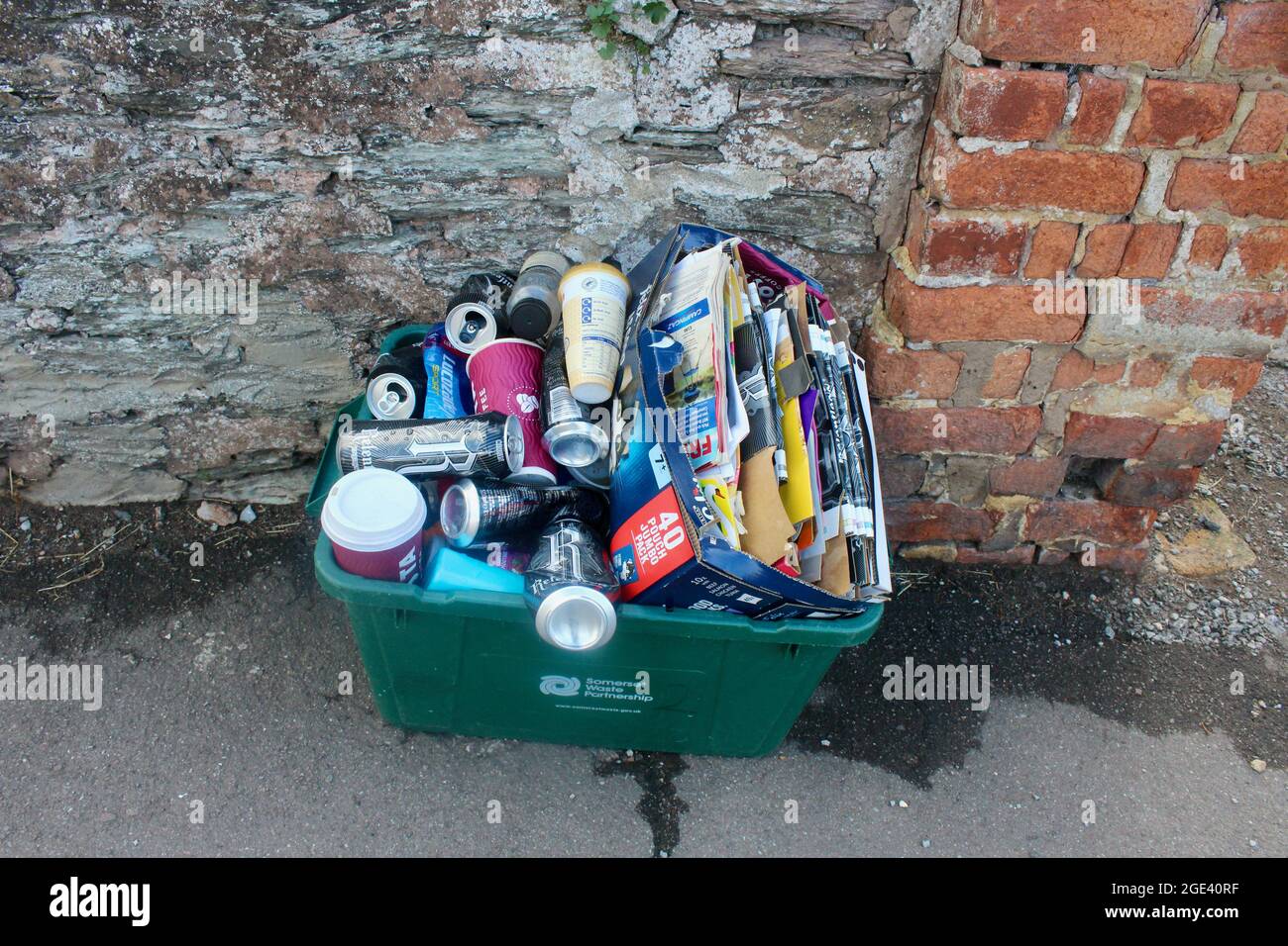 full neatly packed green plastic recycling box bin in somerset village england uk Stock Photo
