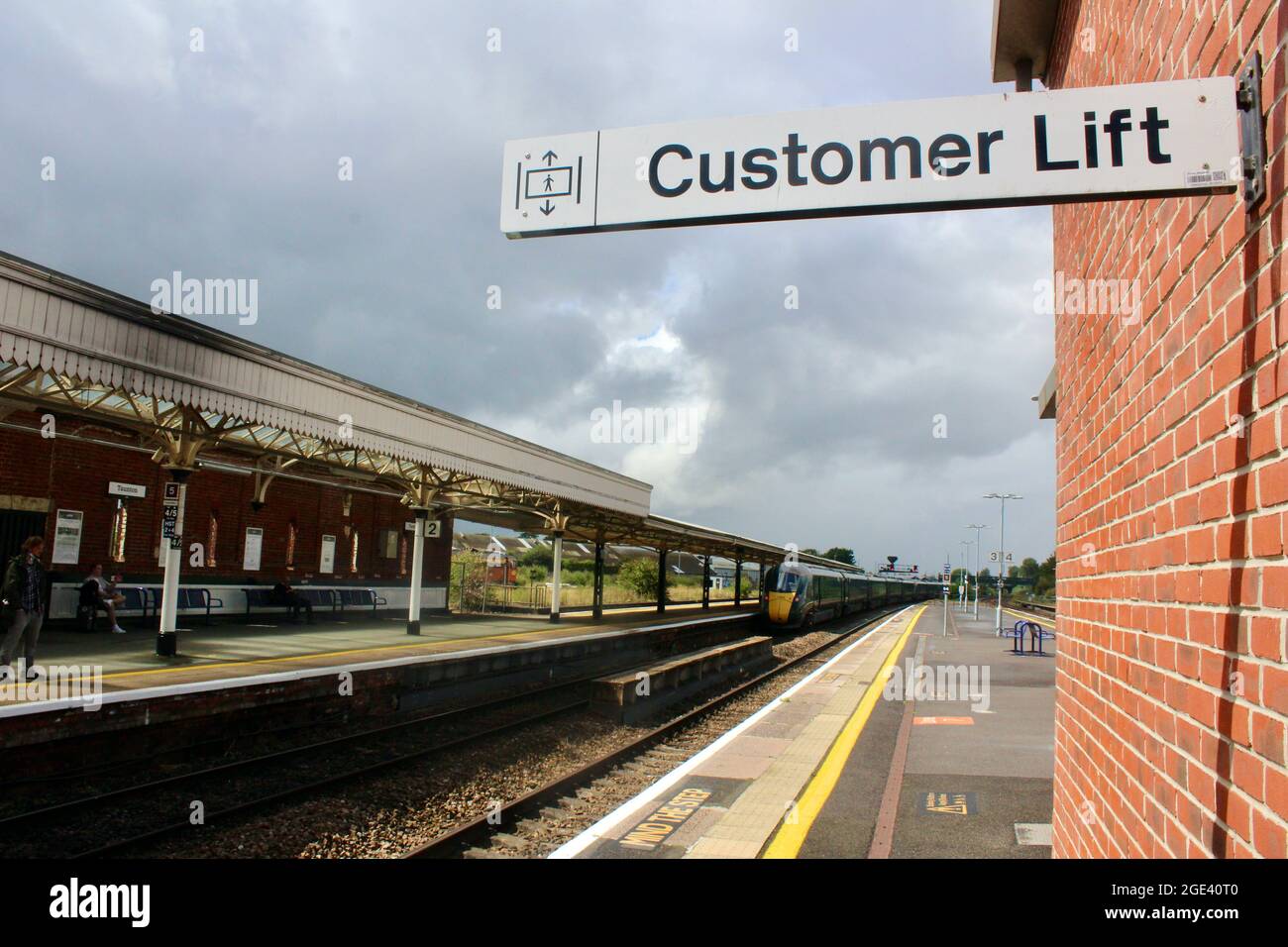 taunton station customer lift sign railway station with departing train