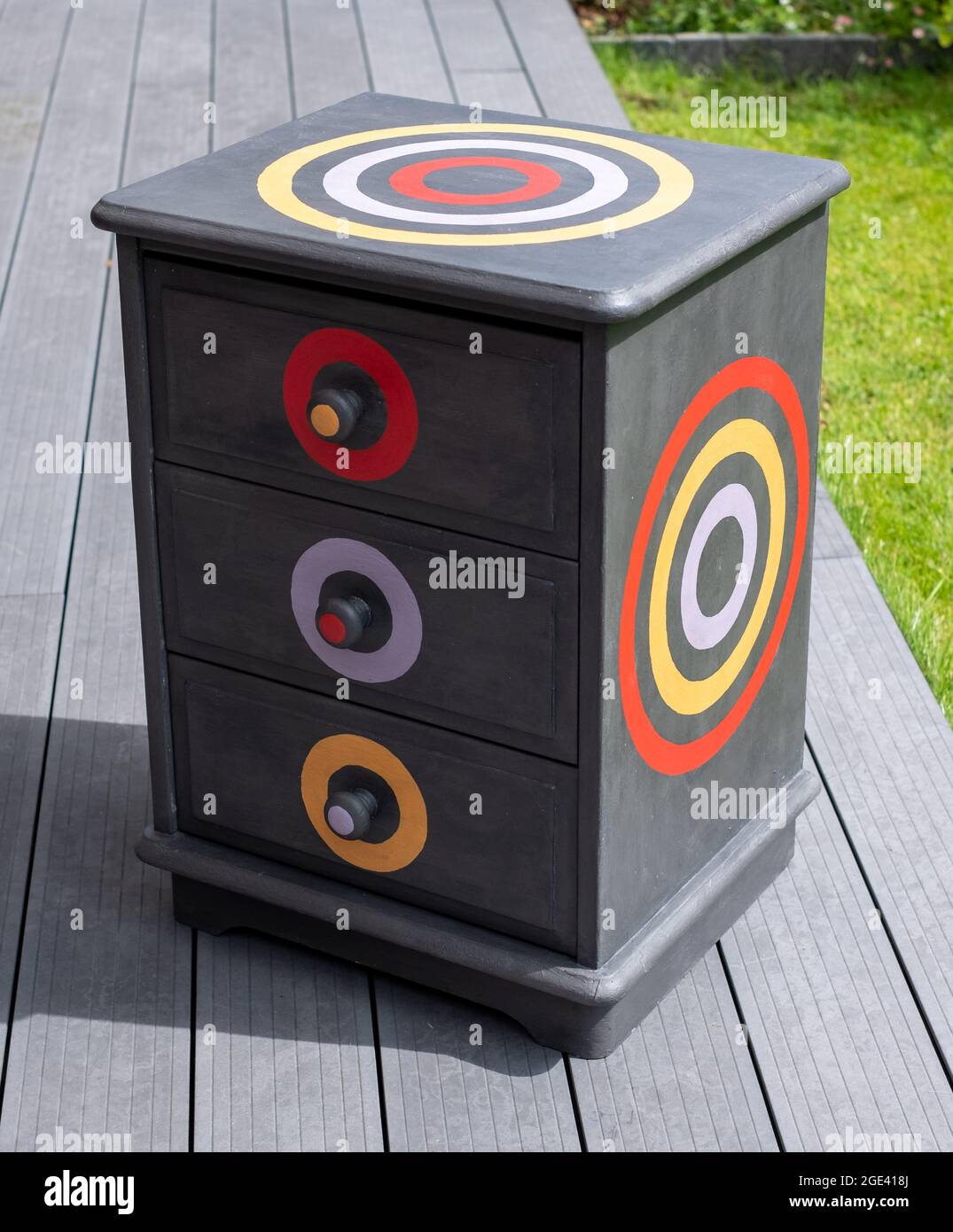 Upcycled dark grey bedside table with three drawers. Bedside table has