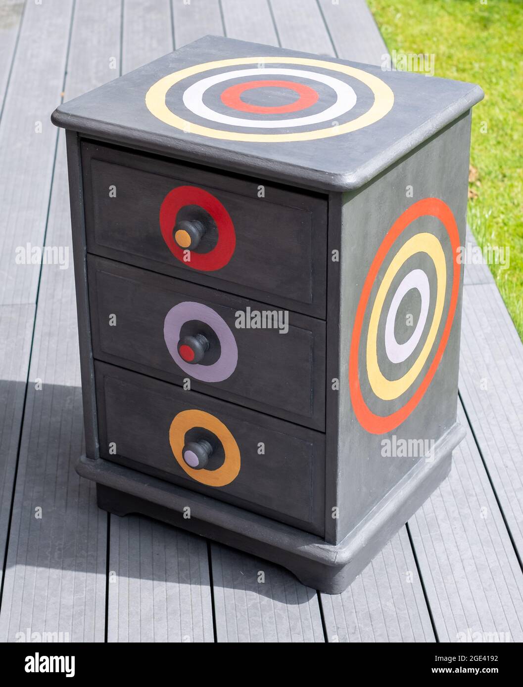 Upcycled dark grey bedside table with three drawers. Bedside table has