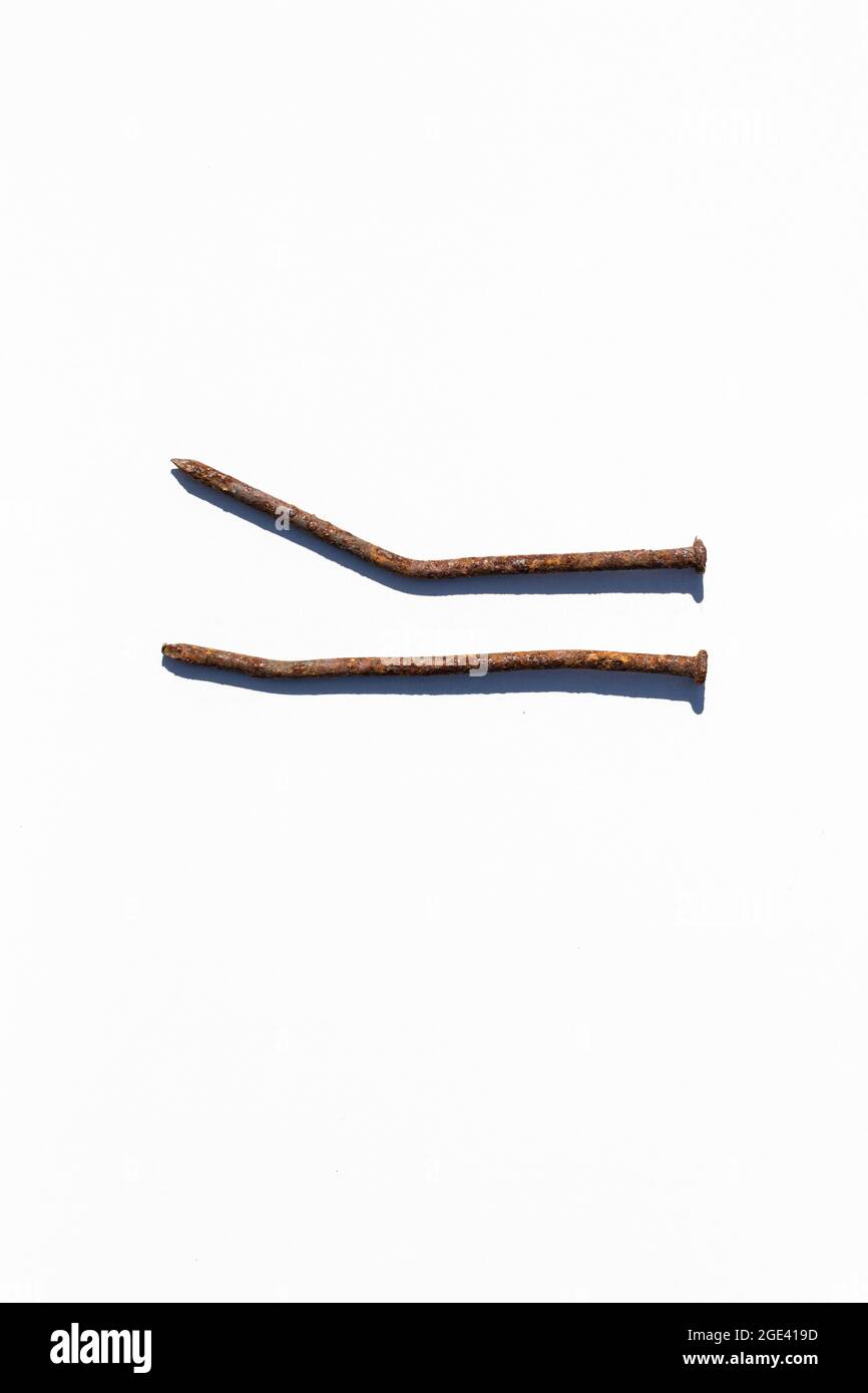 Two old rusty nails on white background. Stock Photo