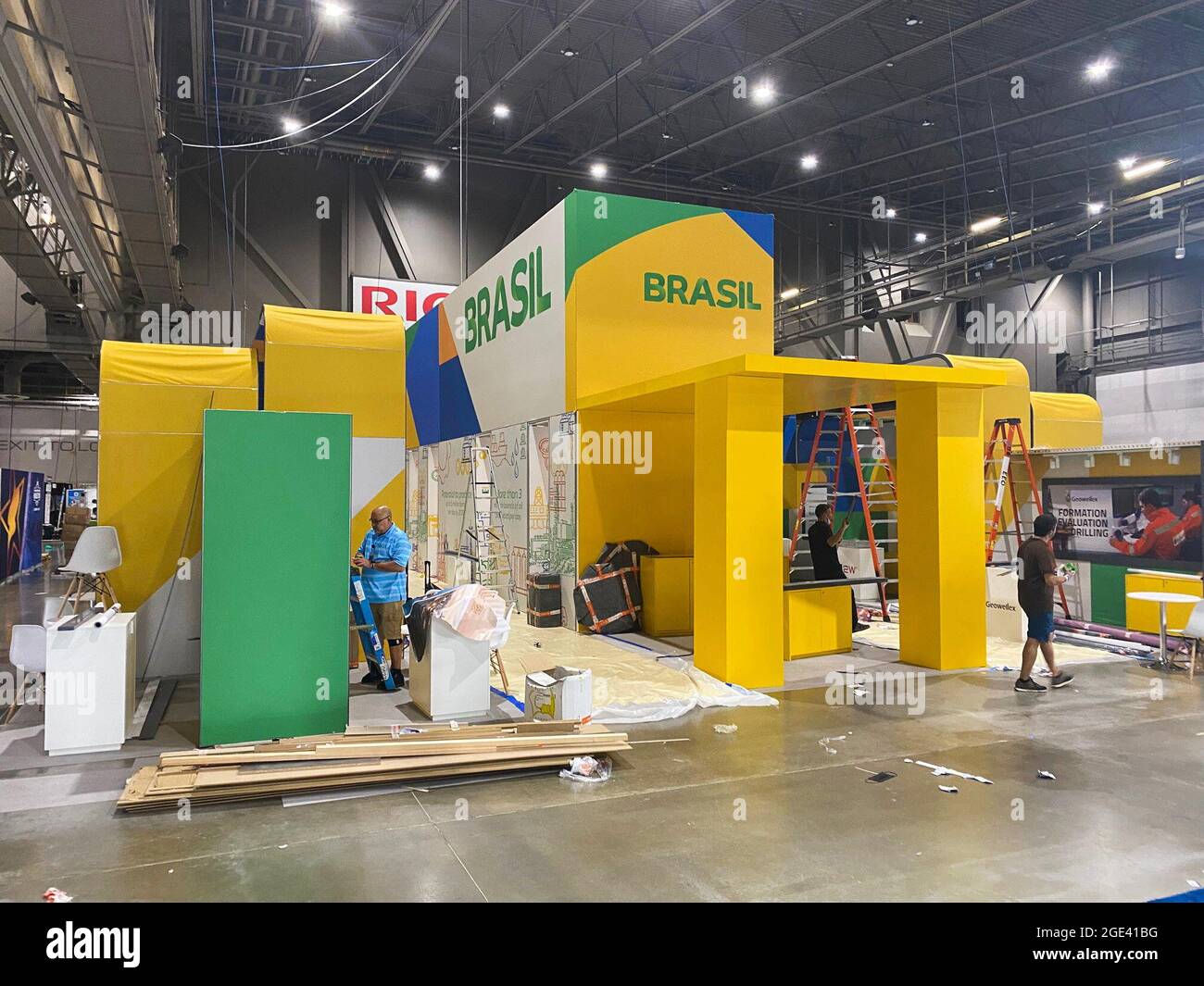 Workers assemble an exhibit booth for Brazil to showcase its offshore oil production at the Offshore Technology Conference in Houston, Texas, U.S., August 14, 2021. Picture taken August 14, 2021. The energy industry showcase opens on Monday. REUTERS/Gary McWilliams Stock Photo