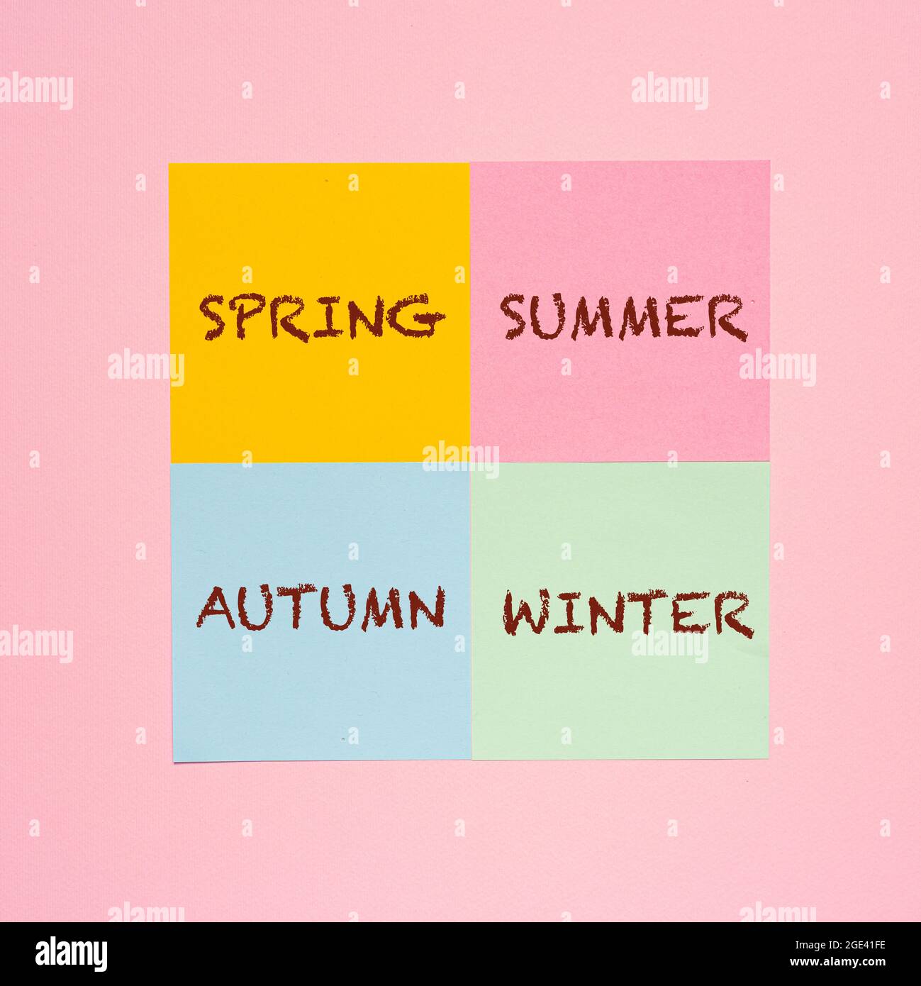 some colored sheets with the name of the four seasons Stock Photo