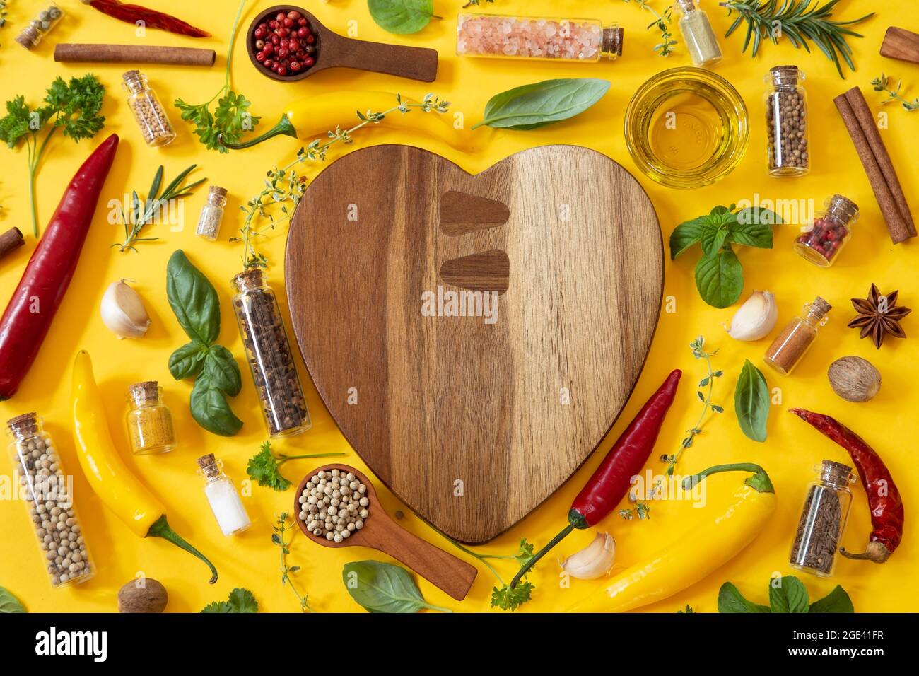 Various herbs and spices on yellow background Stock Photo