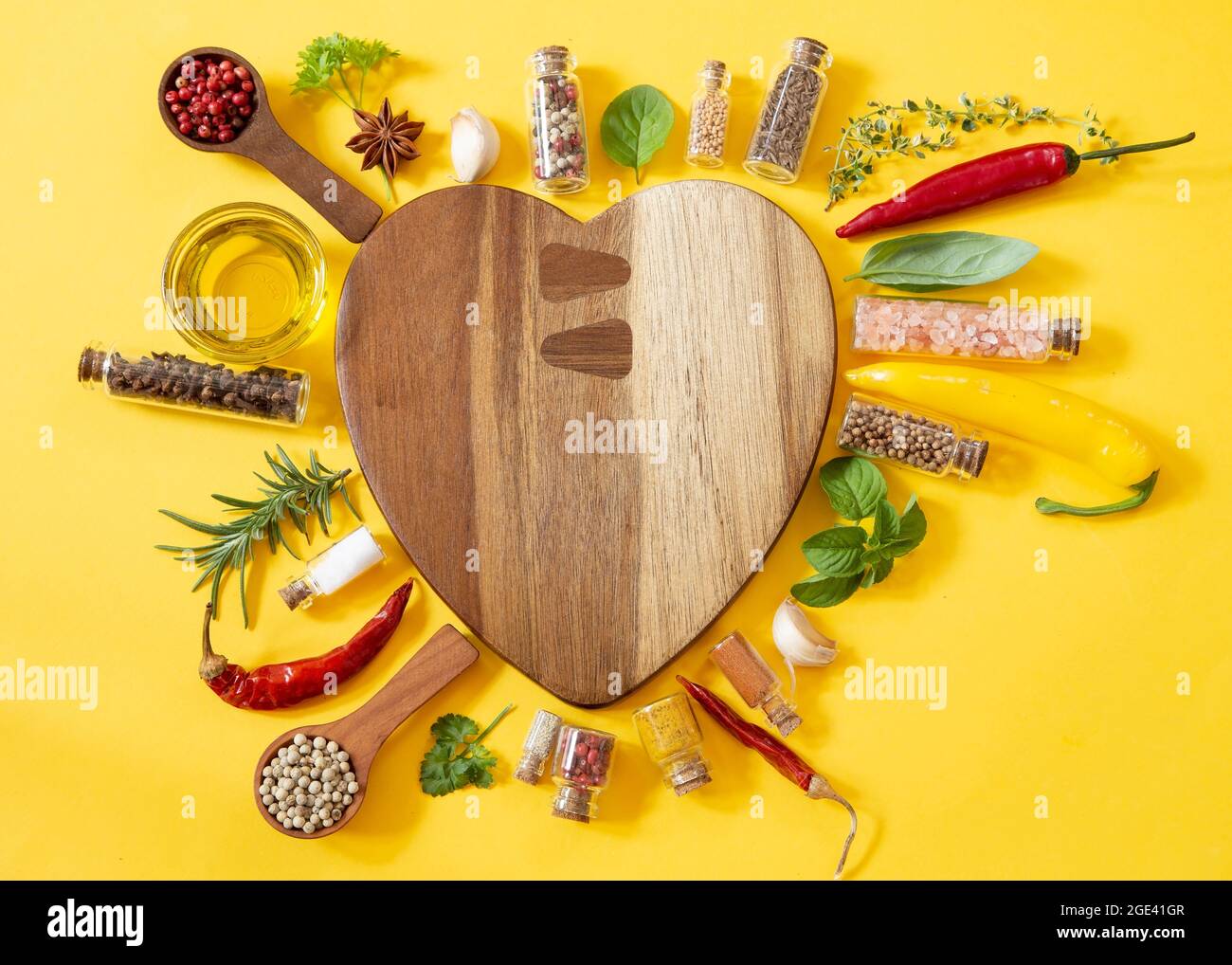 Various herbs and spices on yellow background Stock Photo