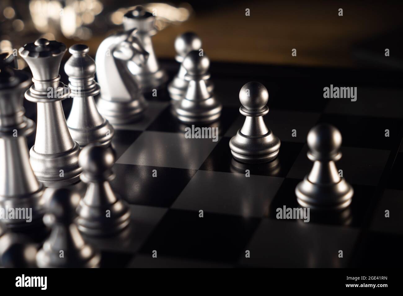 View at the chessboard with white chess figures in the focus Stock Photo