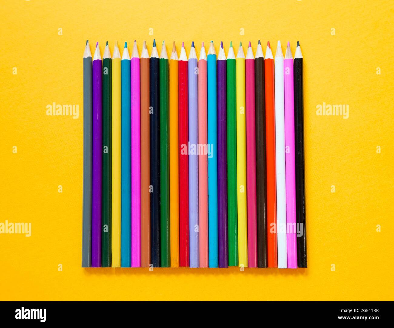 Colored wooden pencils on yellow background Stock Photo Alamy
