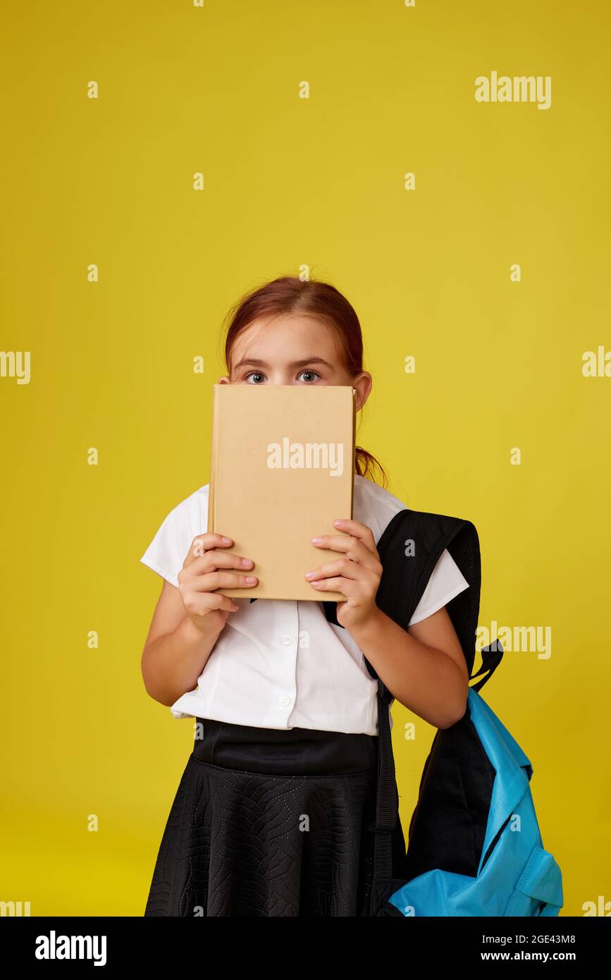 cute happy schoolgirl with backpack and book Stock Photo - Alamy