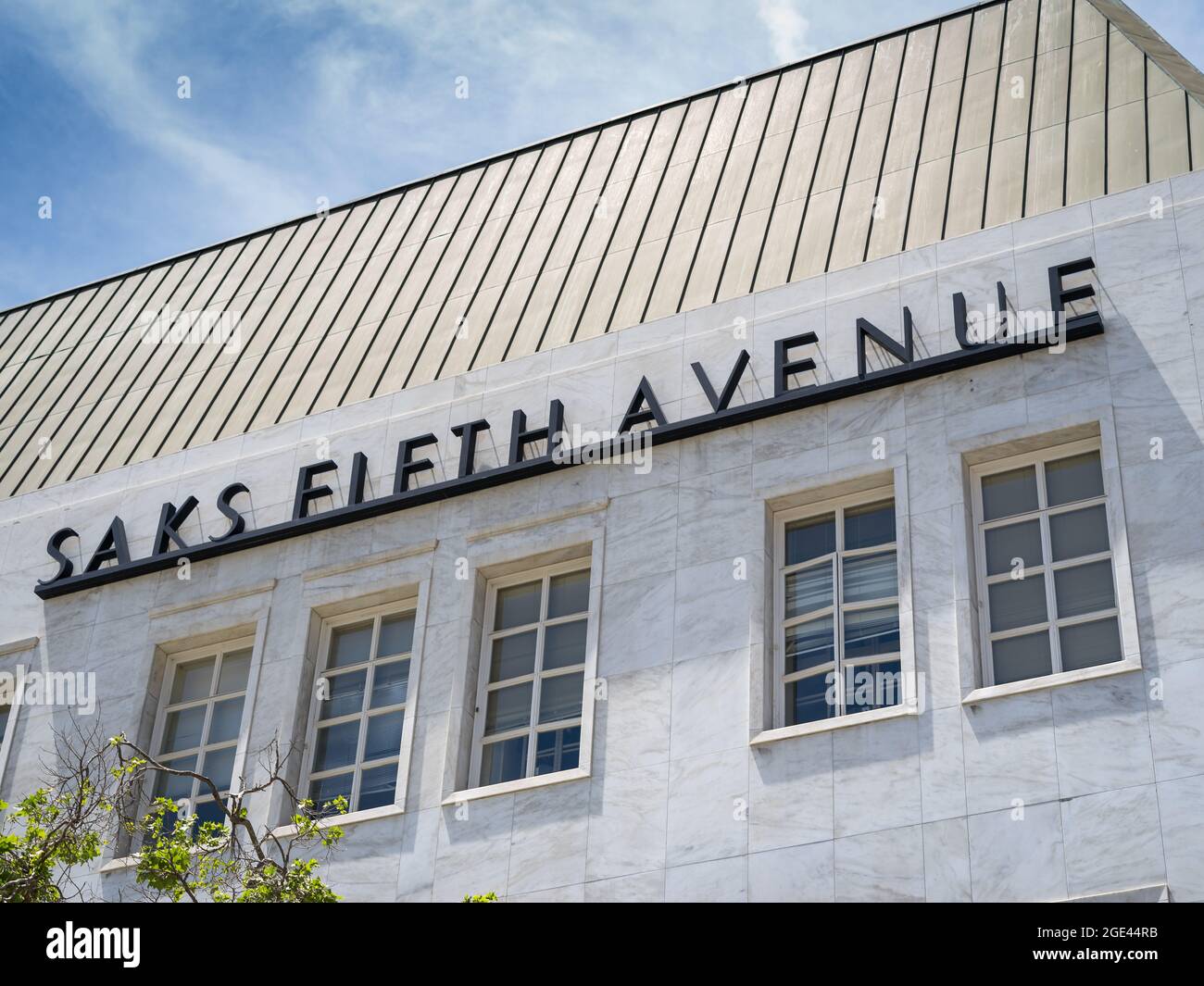 Beverly Hills, CA / USA - May 4, 2018: Iconic Saks Fifth Avenue store name high on white marble exterior invites shoppers to the New York-based retail Stock Photo