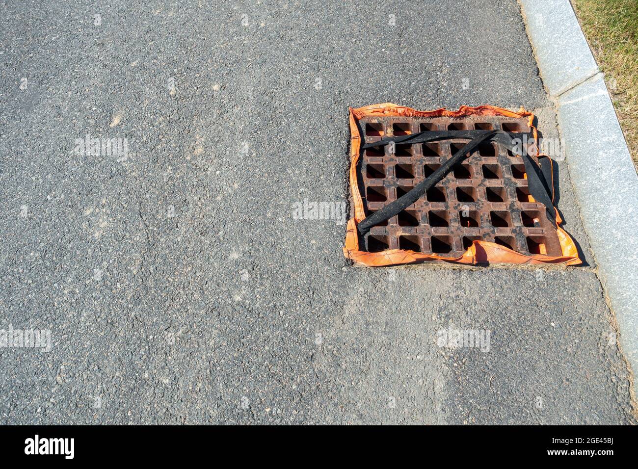 Below Grate Stormdrain Filter, a drop inlet filter secured by straps for use during construction to filter debris from stormwater Stock Photo